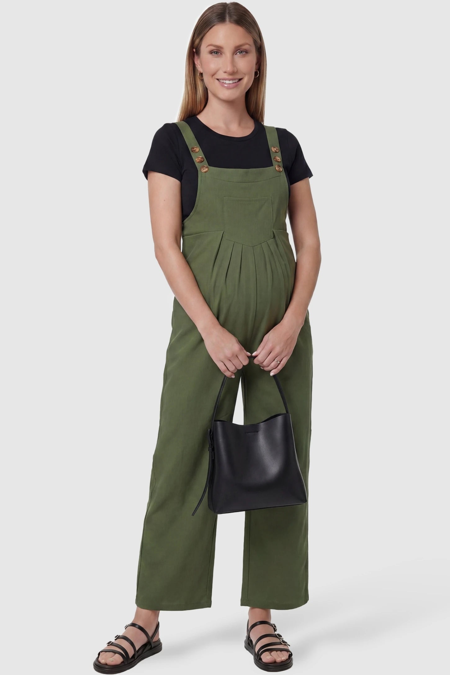Full-Length Pocketed Maternity Jumpsuit in Army Green featuring a relaxed wide-leg cut on a pregnant model, styled lifestyle view.