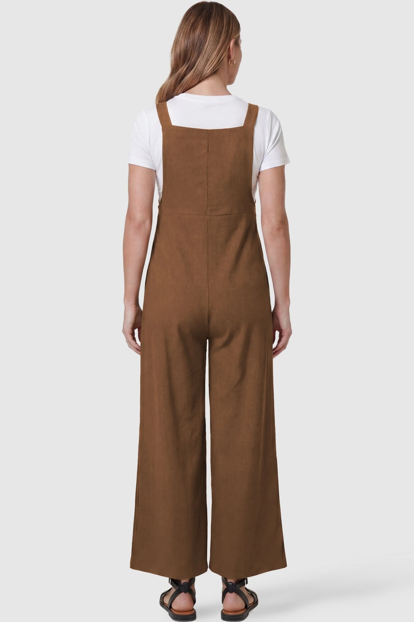 Full-Length Pocketed Maternity Jumpsuit Full-Length Pocketed Maternity Jumpsuit in Camel featuring a relaxed wide-leg cut on a pregnant model, back view.