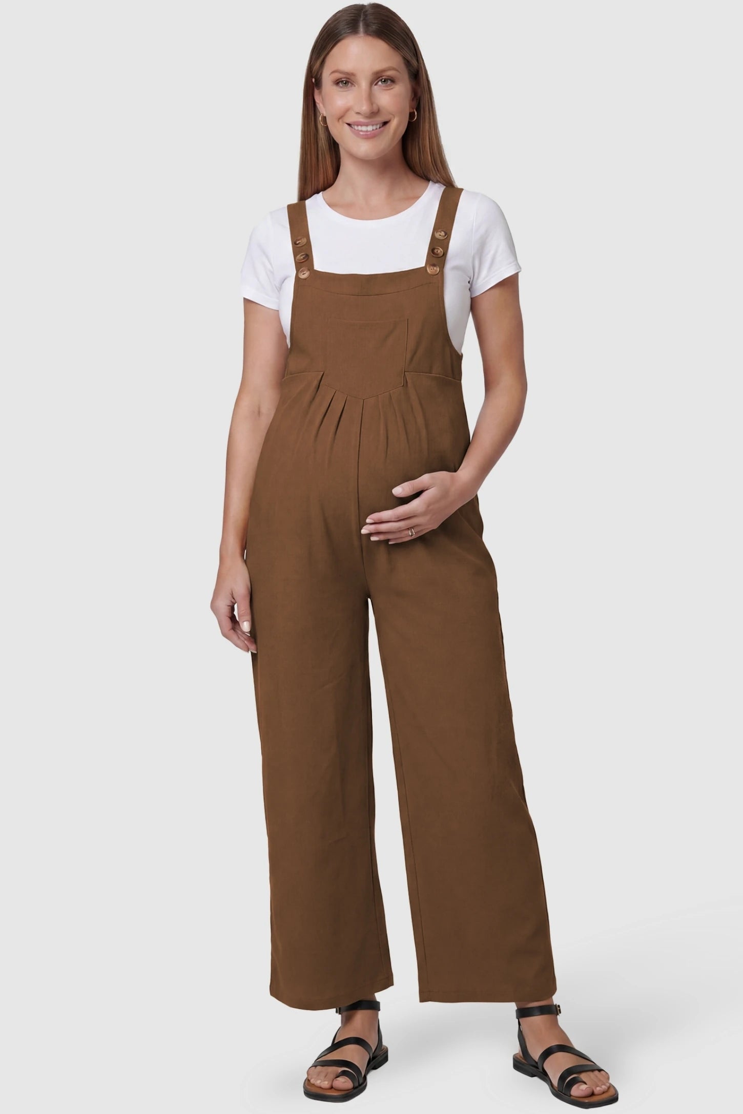 Full-Length Pocketed Maternity Jumpsuit Full-Length Pocketed Maternity Jumpsuit in Camel featuring a relaxed wide-leg cut on a pregnant model, front view.