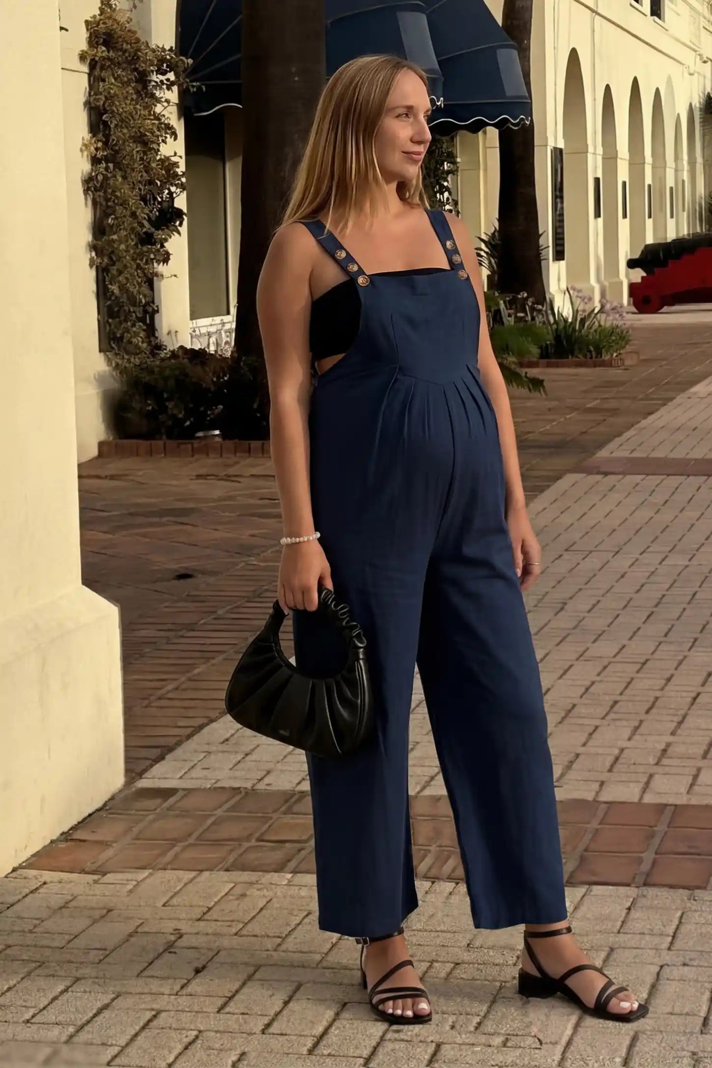 Full-Length Pocketed Maternity Jumpsuit Full-Length Pocketed Maternity Jumpsuit in Dark Blue featuring a relaxed wide-leg cut on a pregnant model, editorial lifestyle view.