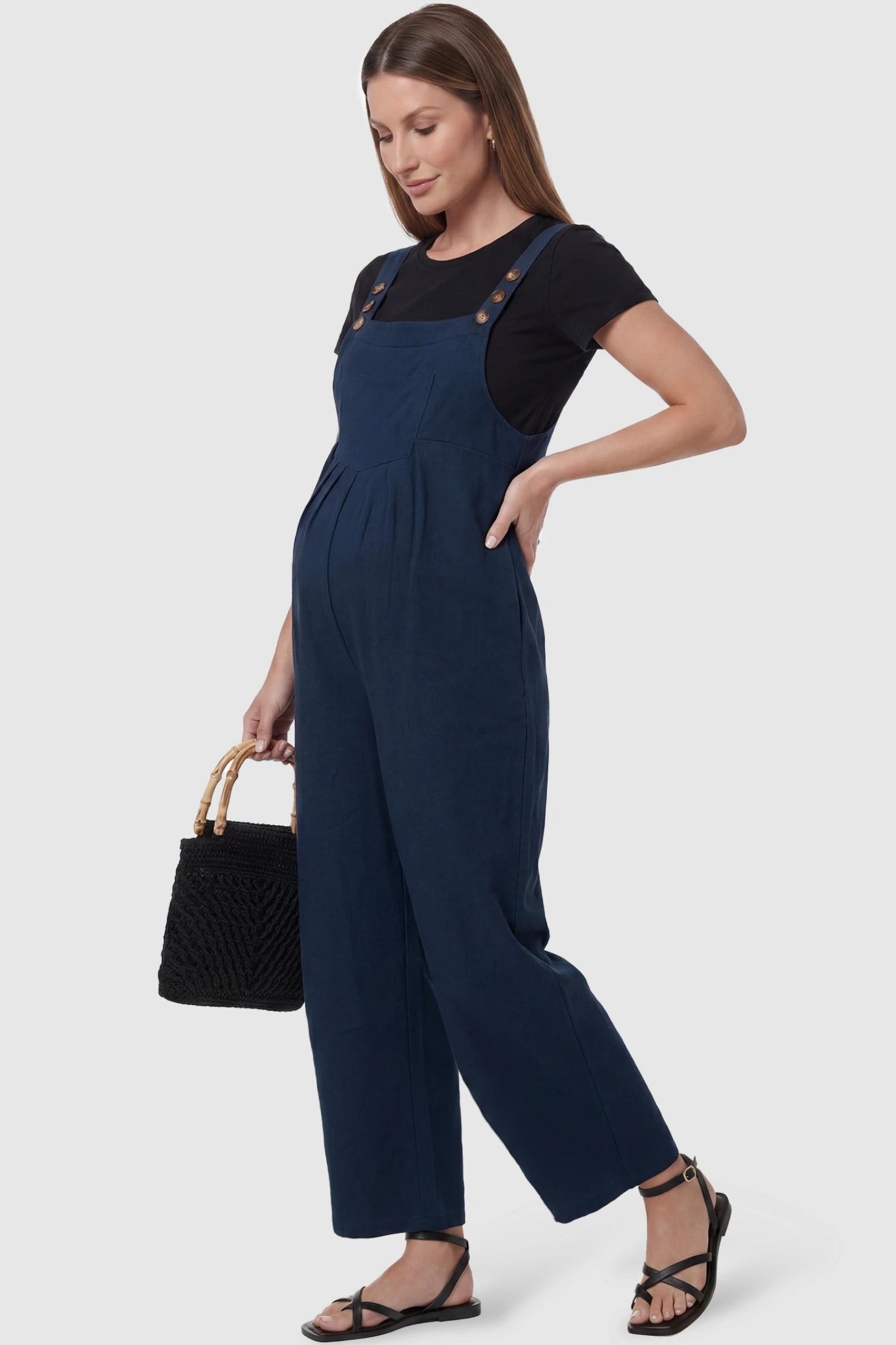 Full-Length Pocketed Maternity Jumpsuit Full-Length Pocketed Maternity Jumpsuit in Dark Blue featuring a relaxed wide-leg cut on a pregnant model, styled lifestyle view.