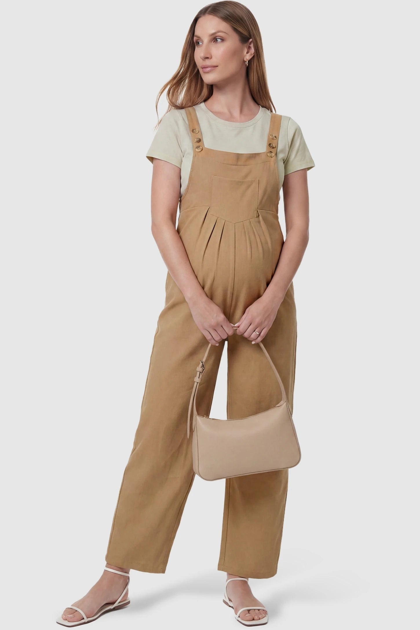 Full-Length Pocketed Maternity Jumpsuit Full-Length Pocketed Maternity Jumpsuit in Khaki featuring a relaxed wide-leg cut on a pregnant model, styled lifestyle view.