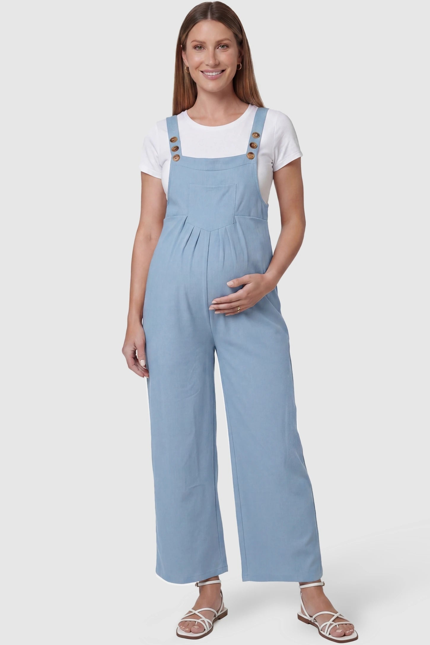 Full-Length Pocketed Maternity Jumpsuit Full-Length Pocketed Maternity Jumpsuit in Light Blue featuring a relaxed wide-leg cut on a pregnant model, front view.