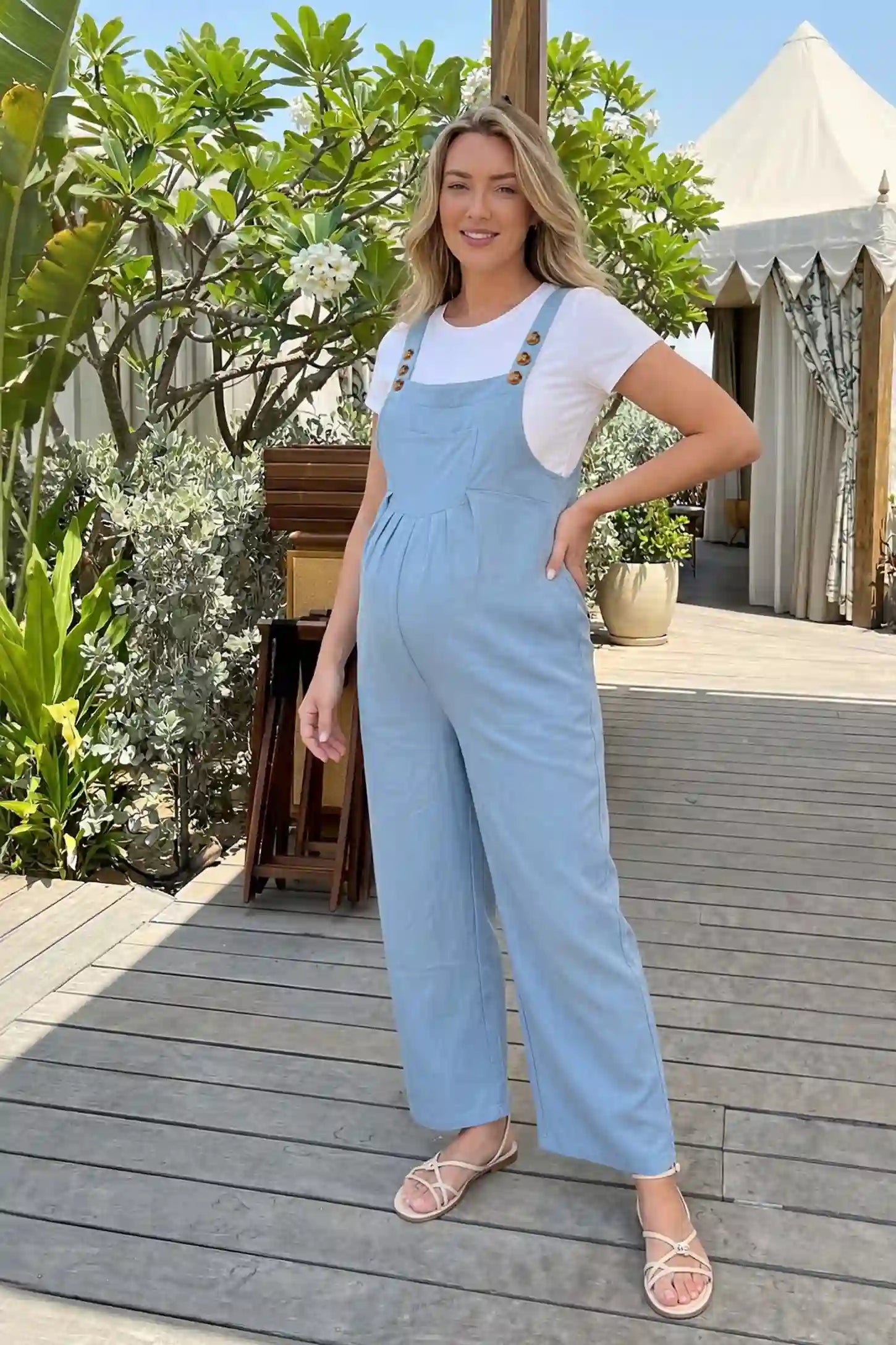 Full-Length Pocketed Maternity Jumpsuit Full-Length Pocketed Maternity Jumpsuit in Light Blue featuring a relaxed wide-leg cut on a pregnant model, ugc view.
