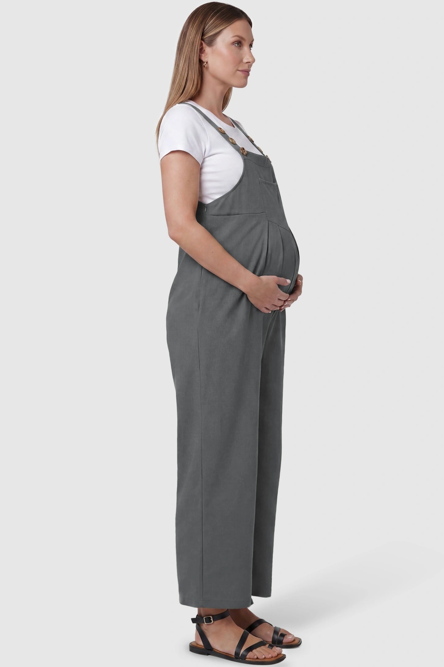 Full-Length Pocketed Maternity Jumpsuit Full-Length Pocketed Maternity Jumpsuit in Light Gray featuring a relaxed wide-leg cut on a pregnant model, side view.