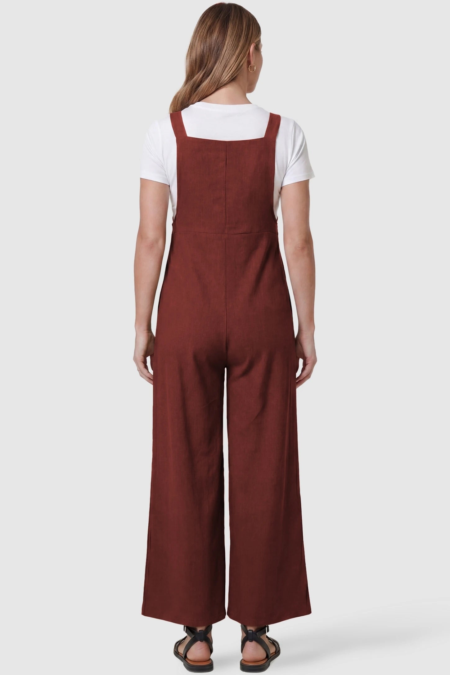 Full-Length Pocketed Maternity Jumpsuit Full-Length Pocketed Maternity Jumpsuit in Orange Red featuring a relaxed wide-leg cut on a pregnant model, back view.