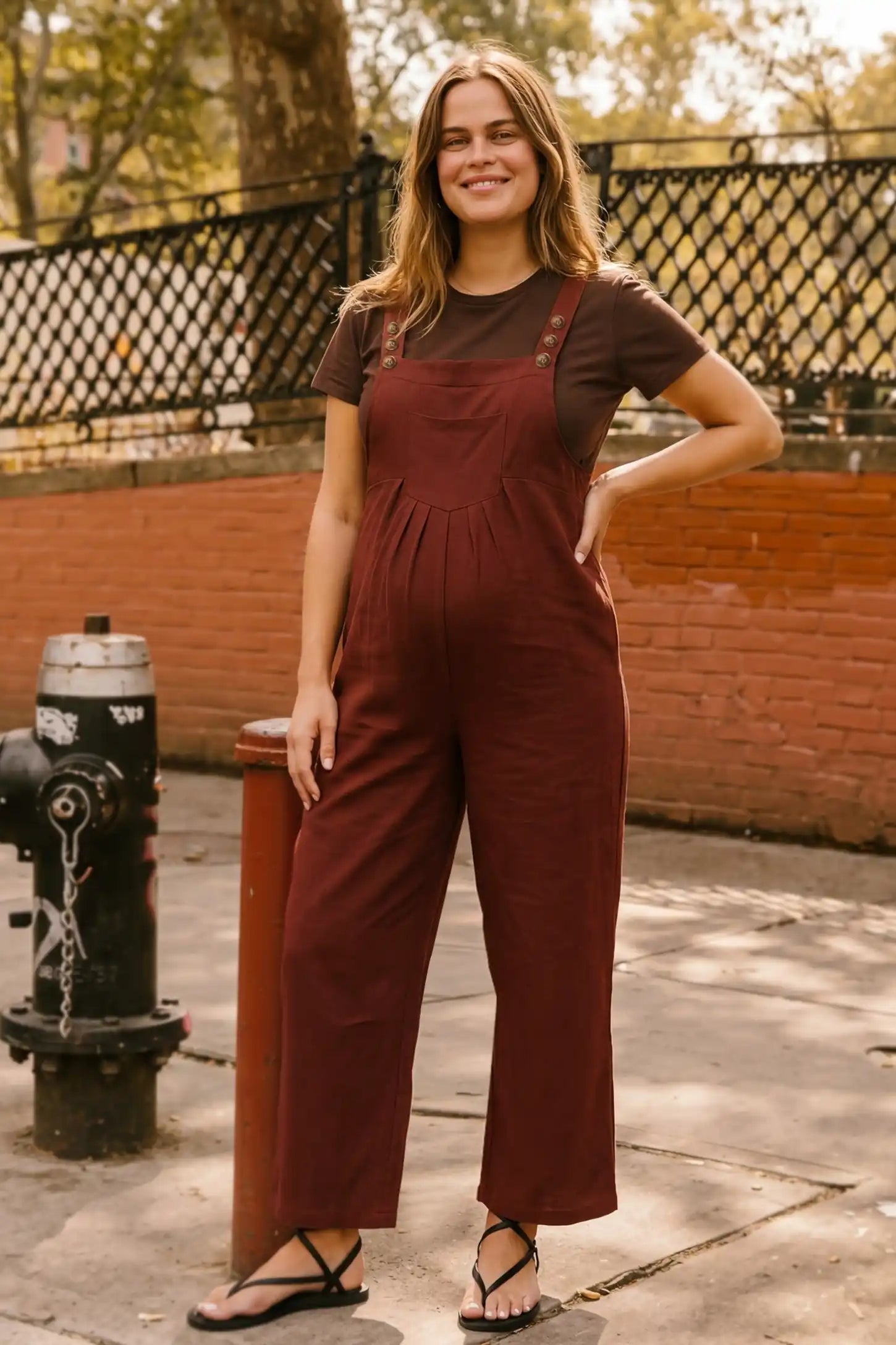 Full-Length Pocketed Maternity Jumpsuit Full-Length Pocketed Maternity Jumpsuit in Orange Red featuring a relaxed wide-leg cut on a non-pregnant model, editorial lifestyle view.