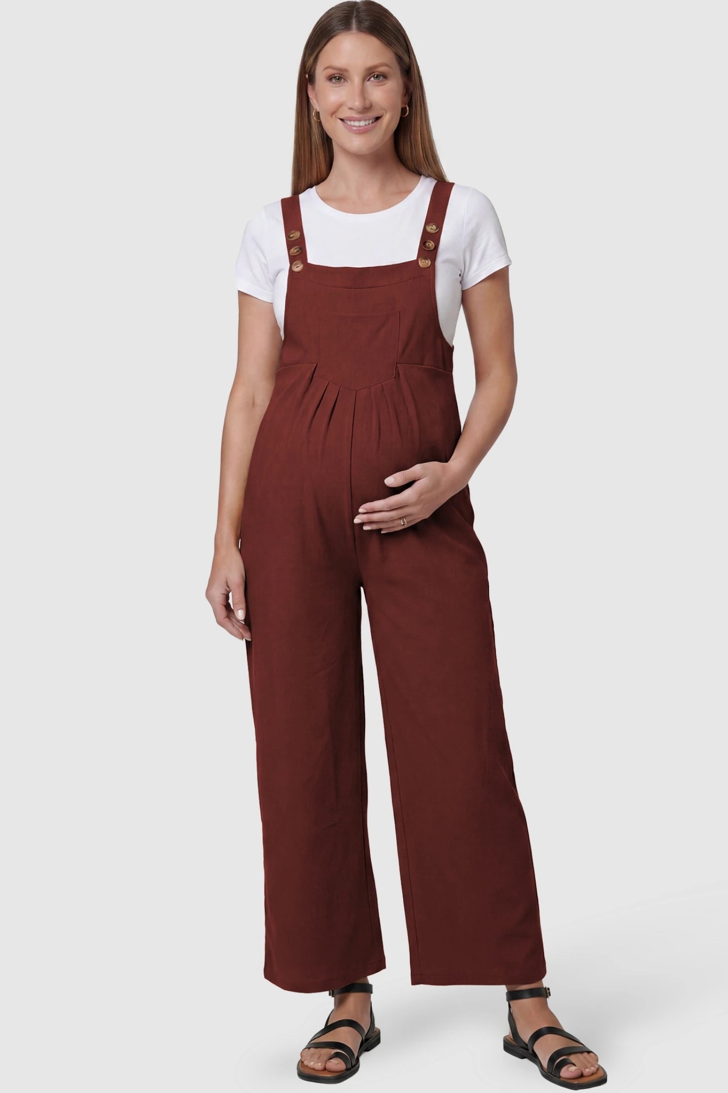 Full-Length Pocketed Maternity Jumpsuit Full-Length Pocketed Maternity Jumpsuit in Orange Red featuring a relaxed wide-leg cut on a pregnant model, front view.