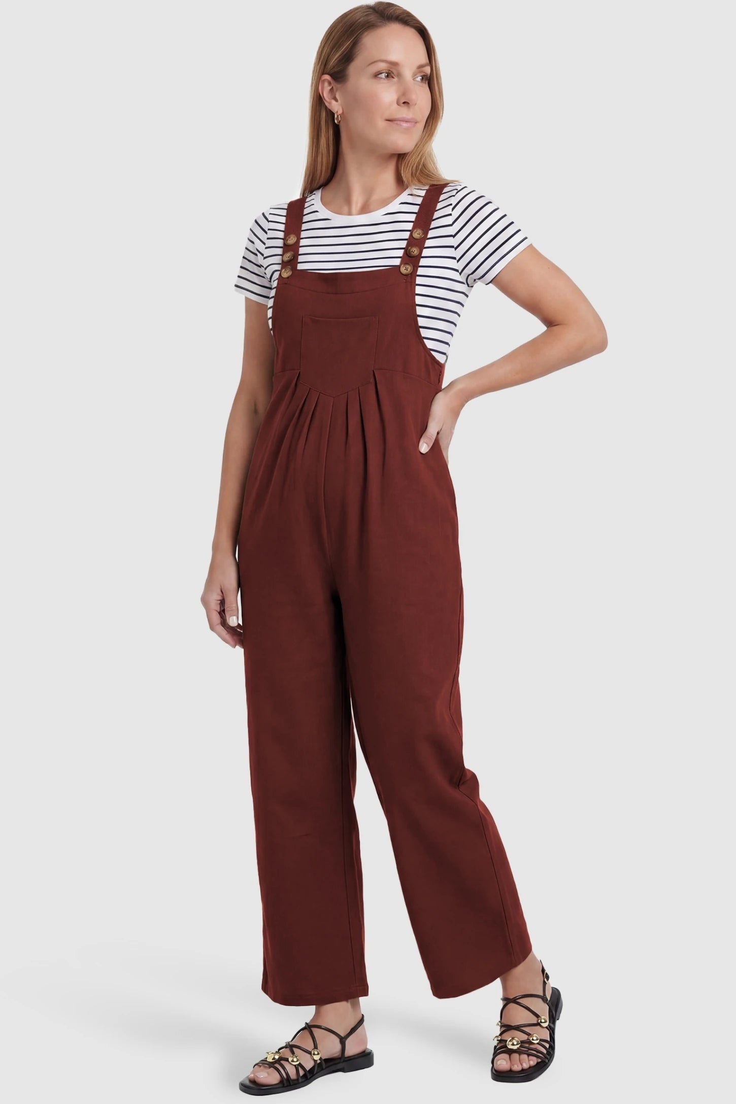 Full-Length Pocketed Maternity Jumpsuit Full-Length Pocketed Maternity Jumpsuit in Orange Red featuring a relaxed wide-leg cut on a pregnant model, postpartum view.