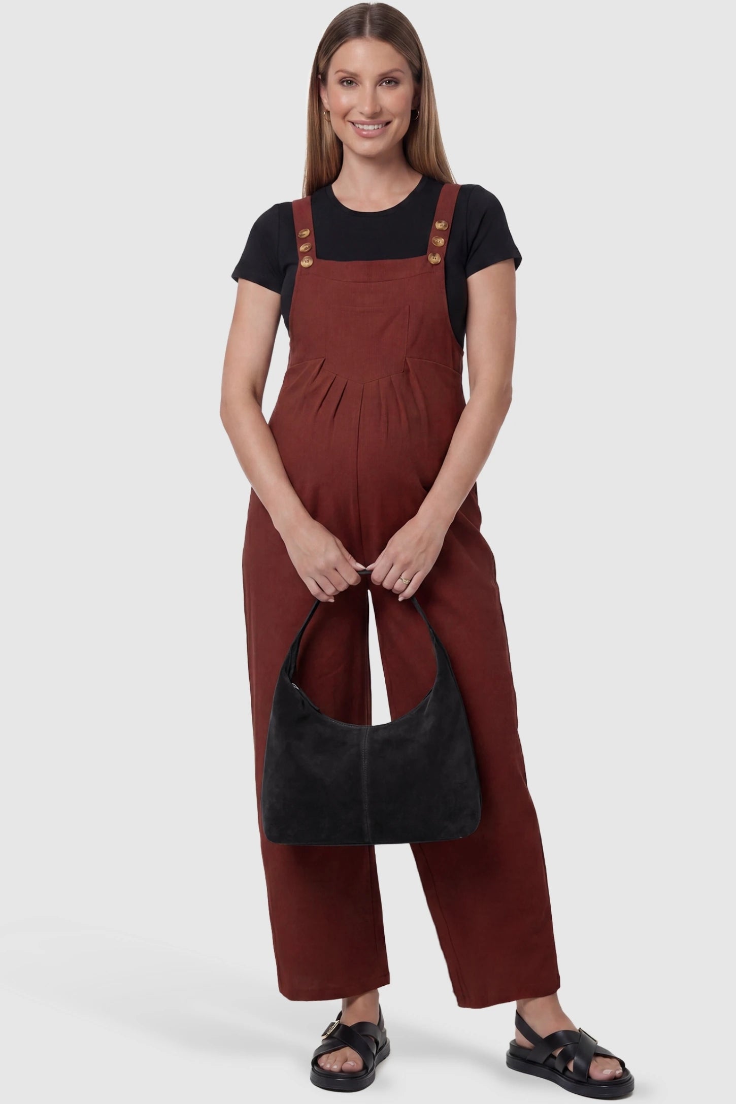 Full-Length Pocketed Maternity Jumpsuit Full-Length Pocketed Maternity Jumpsuit in Orange Red featuring a relaxed wide-leg cut on a pregnant model, styled lifestyle view.