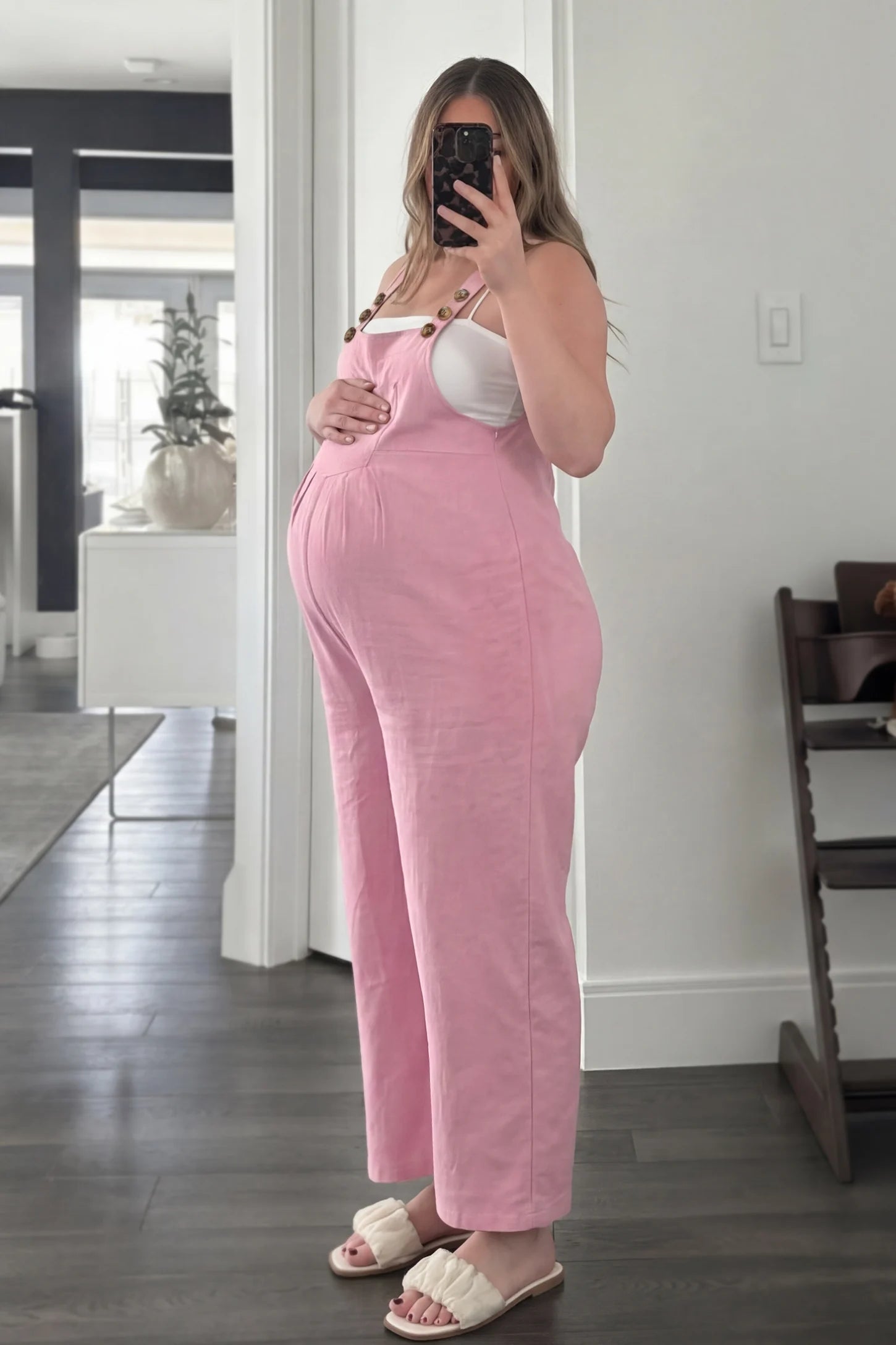 Full-Length Pocketed Maternity Jumpsuit Full-Length Pocketed Maternity Jumpsuit in Pink featuring a relaxed wide-leg cut on a pregnant model, ugc view.