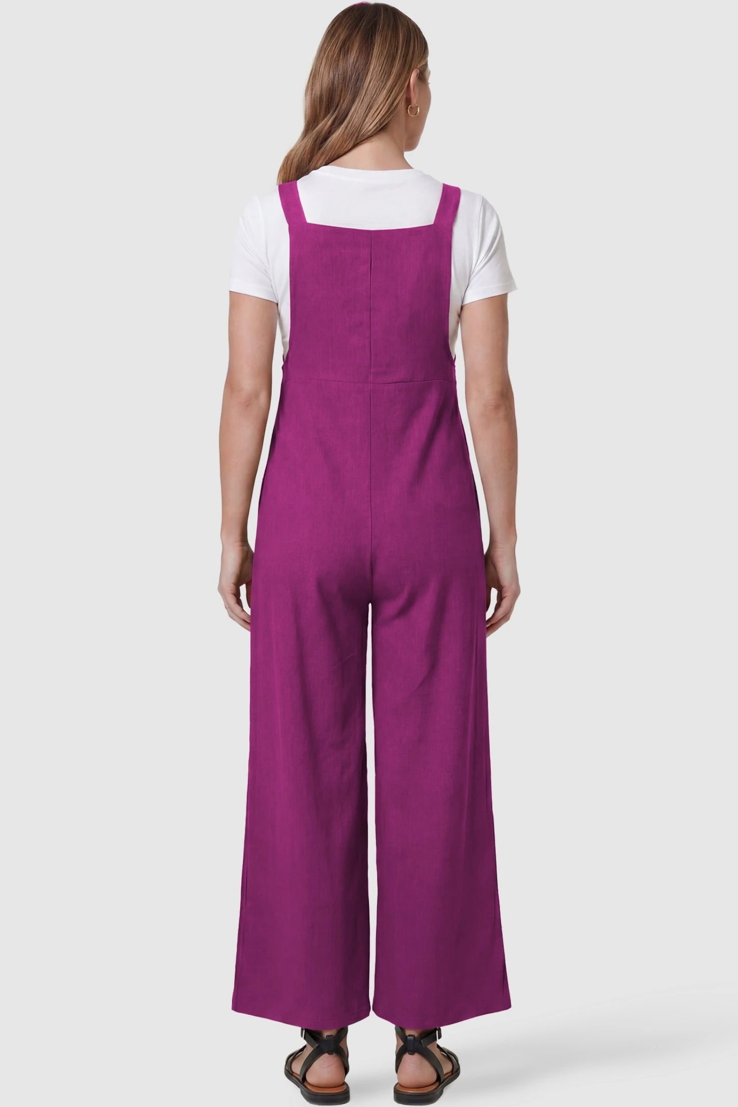 Full-Length Pocketed Maternity Jumpsuit Full-Length Pocketed Maternity Jumpsuit in Wine Red featuring a relaxed wide-leg cut on a pregnant model, back view.