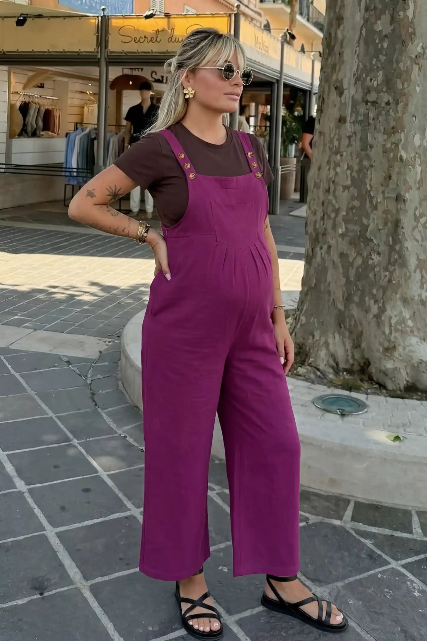 Full-Length Pocketed Maternity Jumpsuit Full-Length Pocketed Maternity Jumpsuit in Wine Red featuring a relaxed wide-leg cut on a pregnant model, editorial lifestyle view.