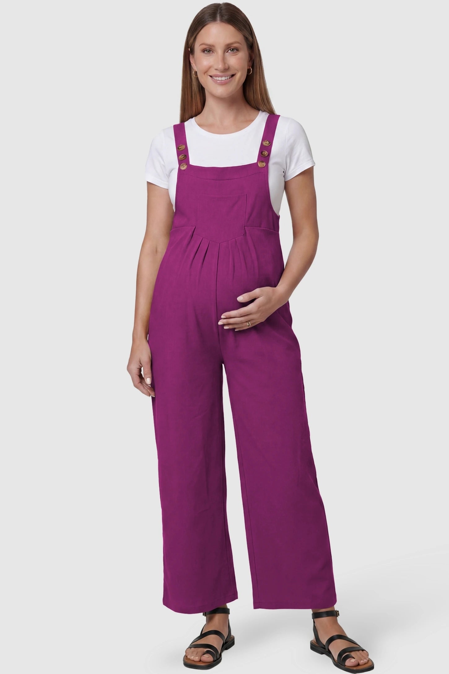Full-Length Pocketed Maternity Jumpsuit Full-Length Pocketed Maternity Jumpsuit in Wine Red featuring a relaxed wide-leg cut on a pregnant model, front view.