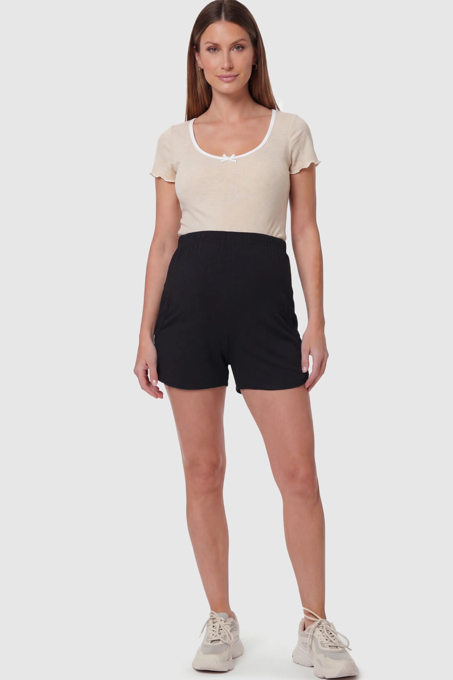 Full Panel Dolphin Hem Maternity Lounge Shorts Full Panel Maternity Lounge Shorts in Black featuring a dolphin hem on a pregnant model showing full body.