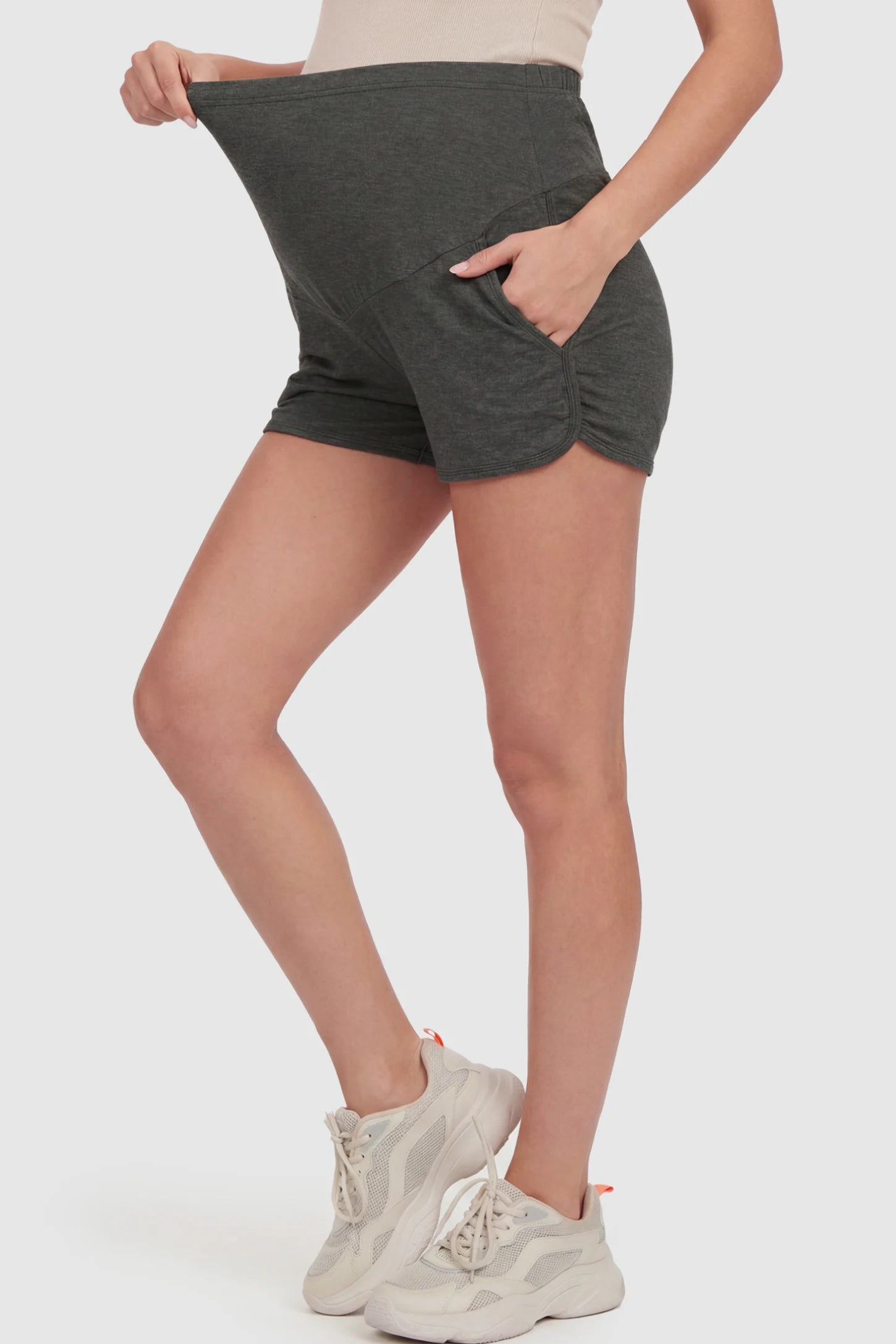 Full Panel Dolphin Hem Maternity Lounge Shorts Full Panel Maternity Lounge Shorts in Gray featuring a dolphin hem on a pregnant model showing side.