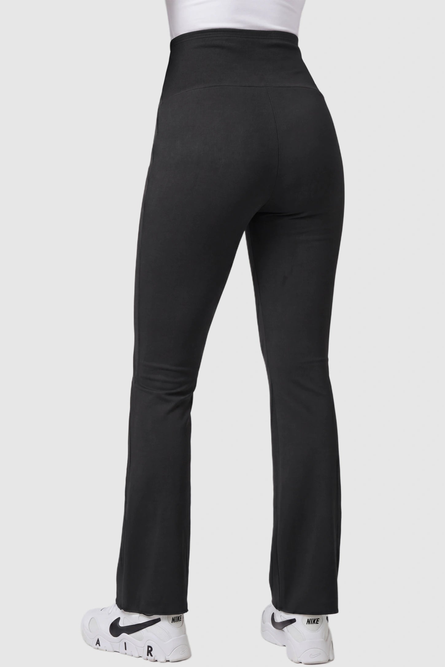 Full Panel Pocketed Flare Leg Maternity Leggings Full Panel Pocketed Flare Leg Maternity Leggings in Black featuring high stretch on a pregnant model, back view.