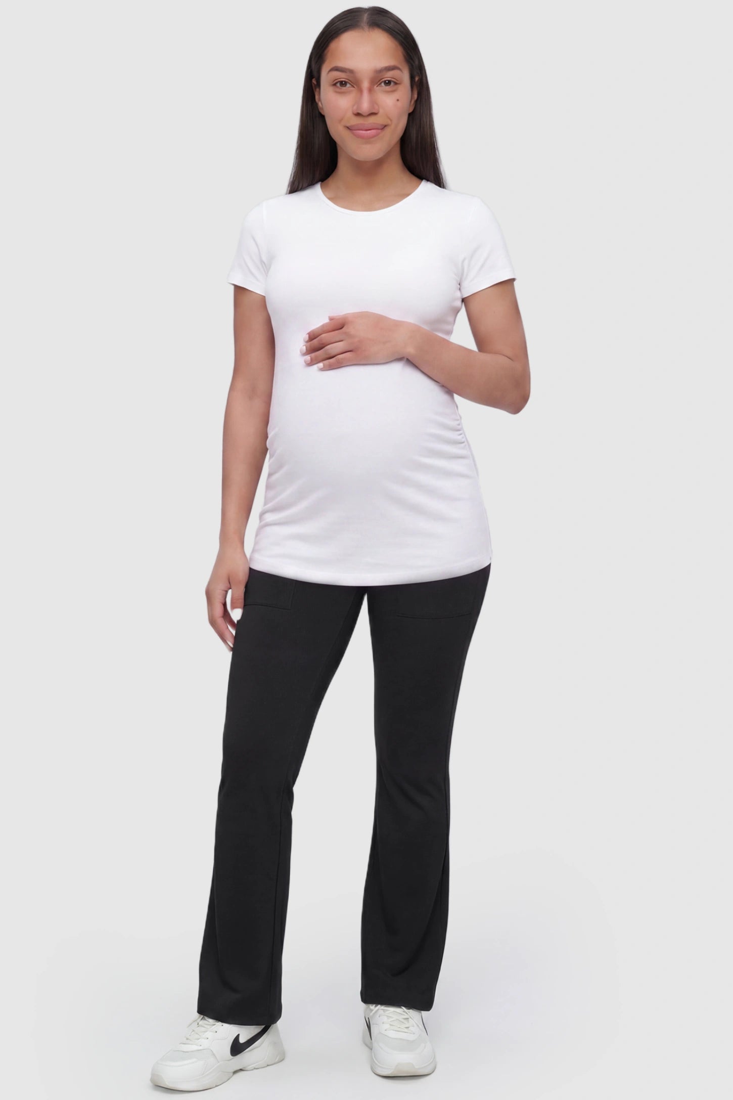 Full Panel Pocketed Flare Leg Maternity Leggings in Black featuring a ribbed over-the-bump panel on a pregnant model, full body view.