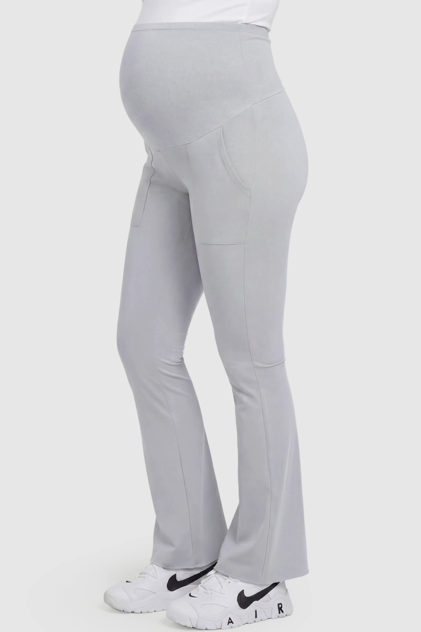 Full Panel Pocketed Flare Leg Maternity Leggings Full Panel Pocketed Flare Leg Maternity Leggings in Gray featuring a ribbed over-the-bump panel on a pregnant model, side view.