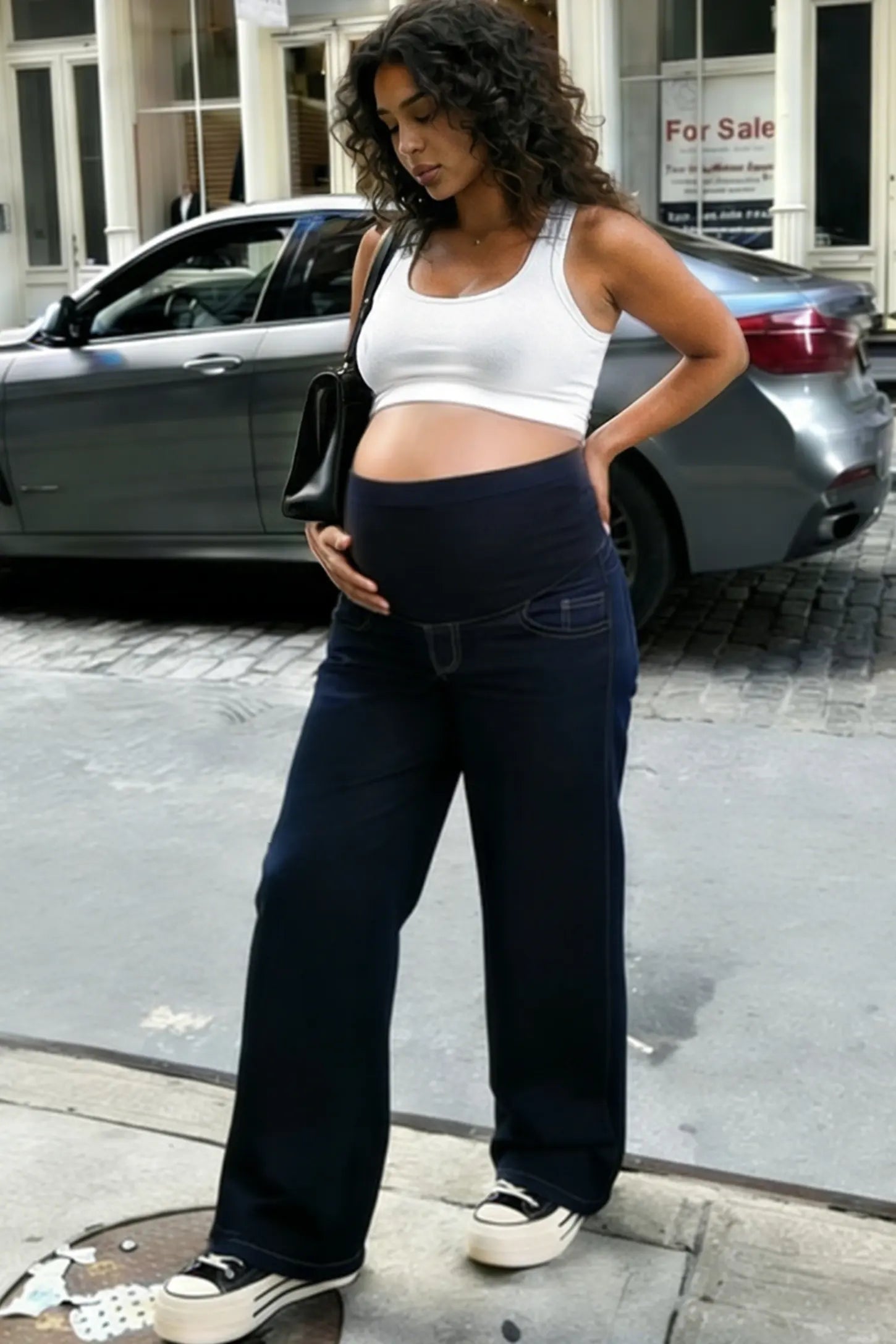 Full Panel Relaxed Wide Leg Maternity Jeans Full Panel Wide-Leg Maternity Jeans in Blue featuring a belly panel on a pregnant woman.