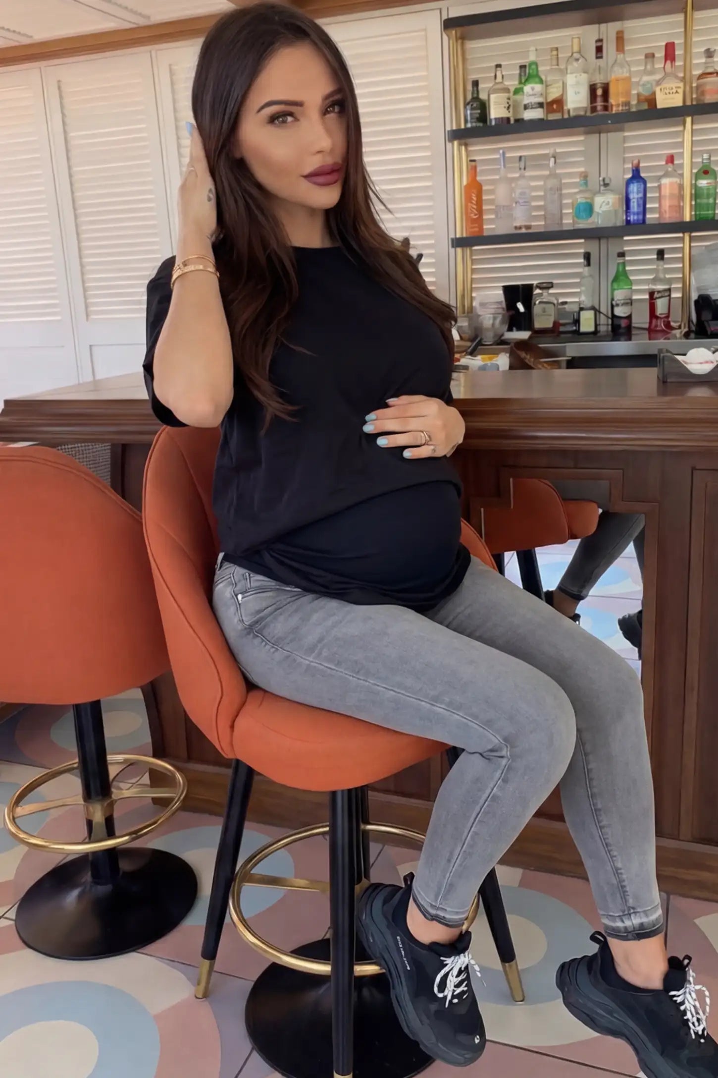 Full Panel Released Hem Maternity Skinny Jeans Full Panel Released Hem Maternity Skinny Jeans in Gray featuring a released hem and over-the-belly panel on a pregnant woman.