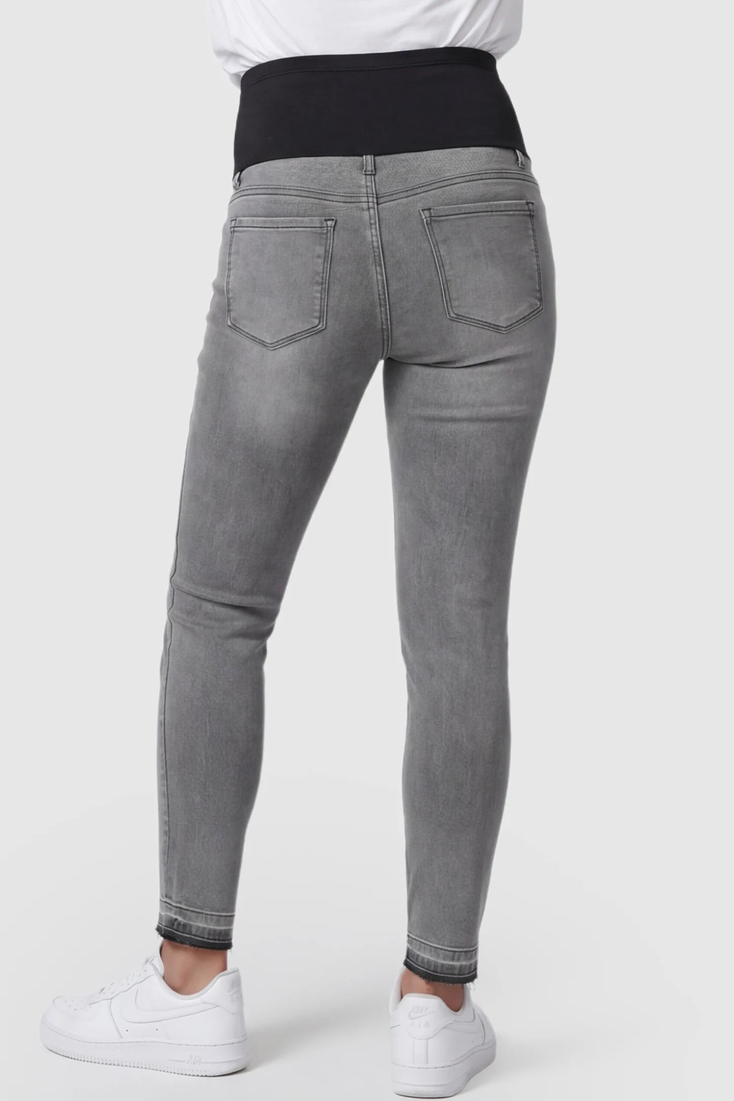 Full Panel Released Hem Maternity Skinny Jeans Full Panel Released Hem Maternity Skinny Jeans in Gray featuring a released hem on a pregnant model showing back.
