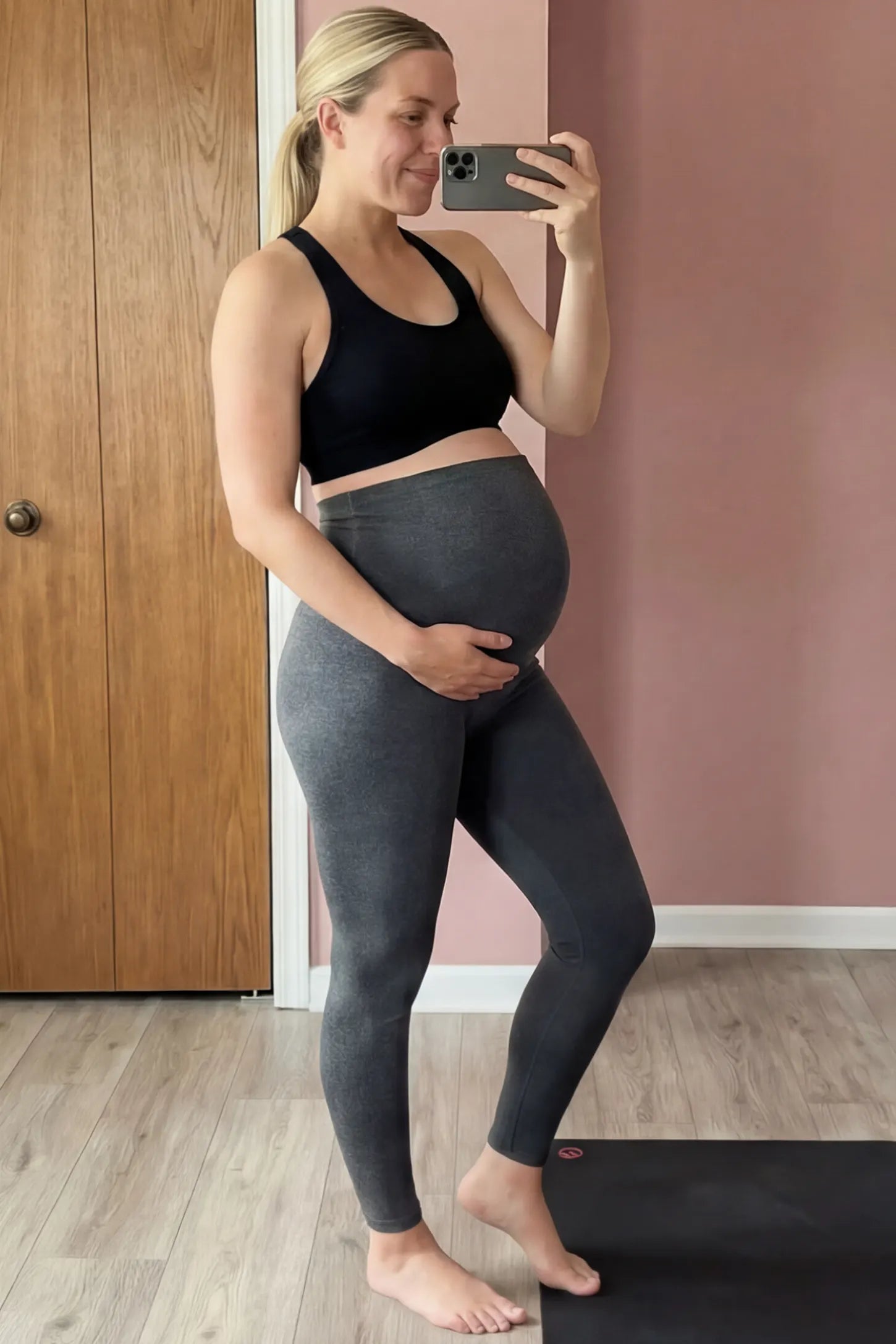 Full Panel Slim Fit Maternity Leggings Full Panel Slim Fit Maternity Leggings in Dark Gray featuring a seamless over-the-belly waistband on a pregnant woman in indoor setting, side view.