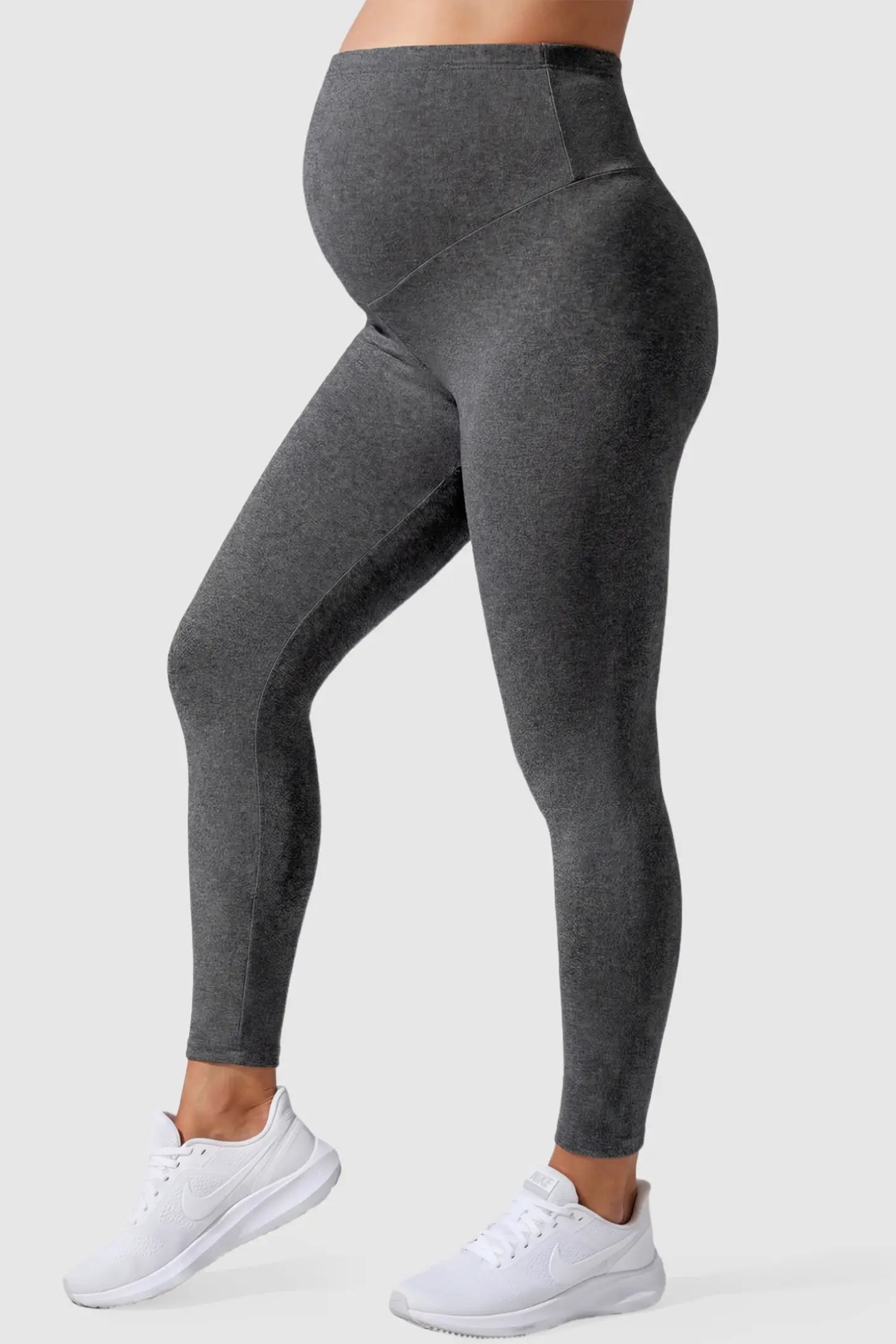 Full Panel Slim Fit Maternity Leggings Full Panel Slim Fit Maternity Leggings in Dark Gray featuring a seamless over-the-belly waistband on a pregnant model, side view.