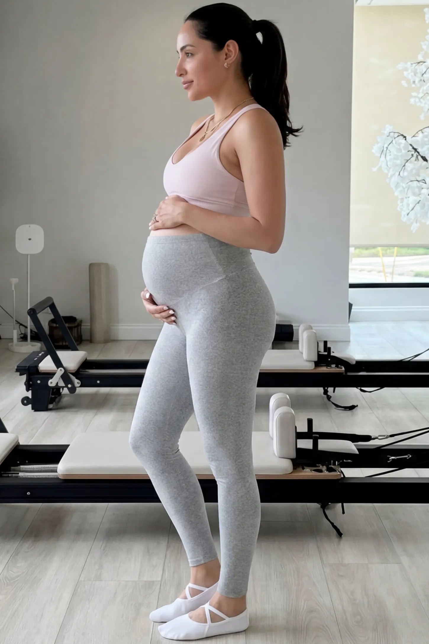 Full Panel Slim Fit Maternity Leggings Full Panel Slim Fit Maternity Leggings in Light Gray featuring a seamless over-the-belly waistband on a pregnant woman in indoor setting, side view.
