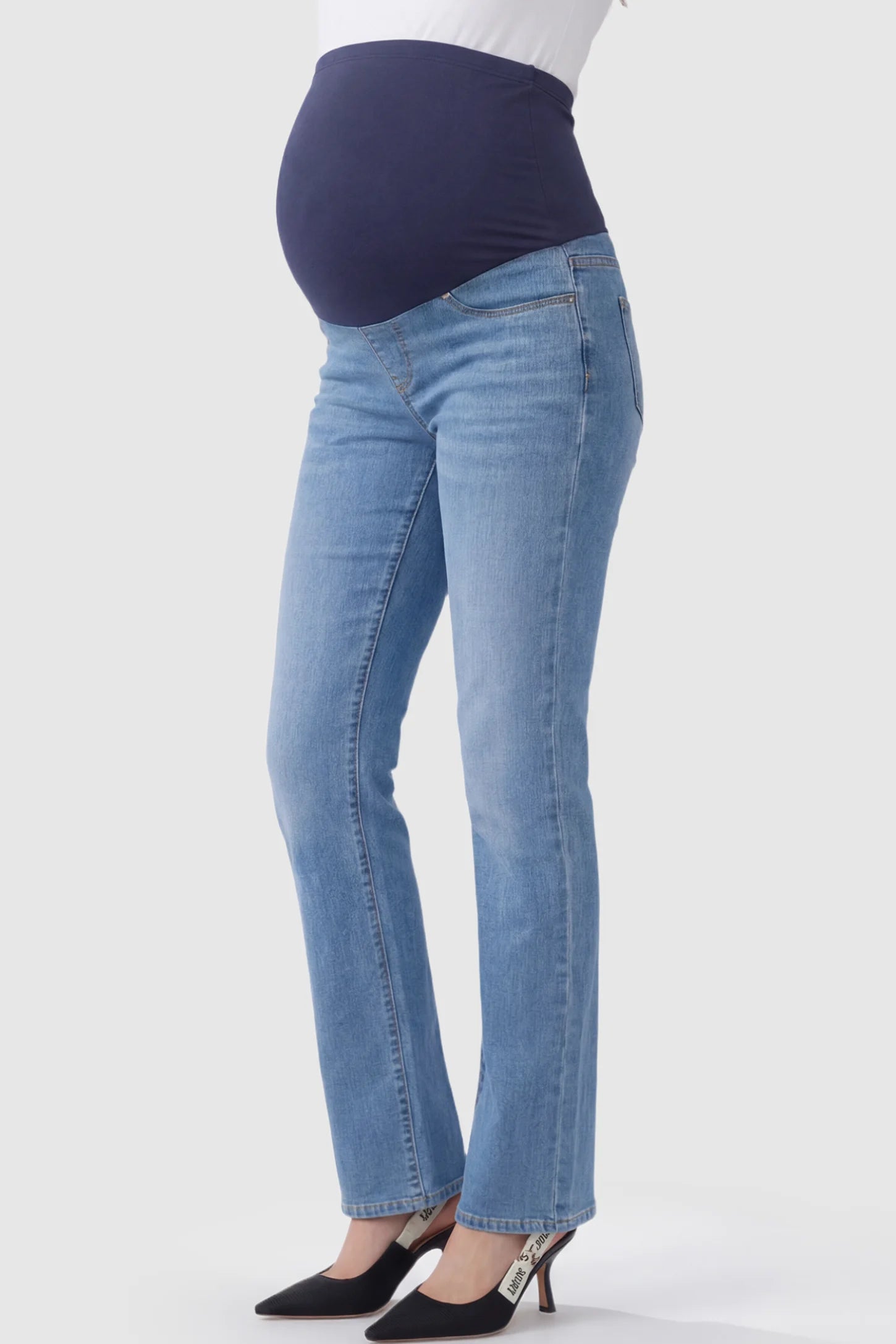Full Panel Classic Straight Leg Maternity Jeans Full Panel Straight Leg Maternity Jeans in blue featuring a stretch support panel on a pregnant model showing side.