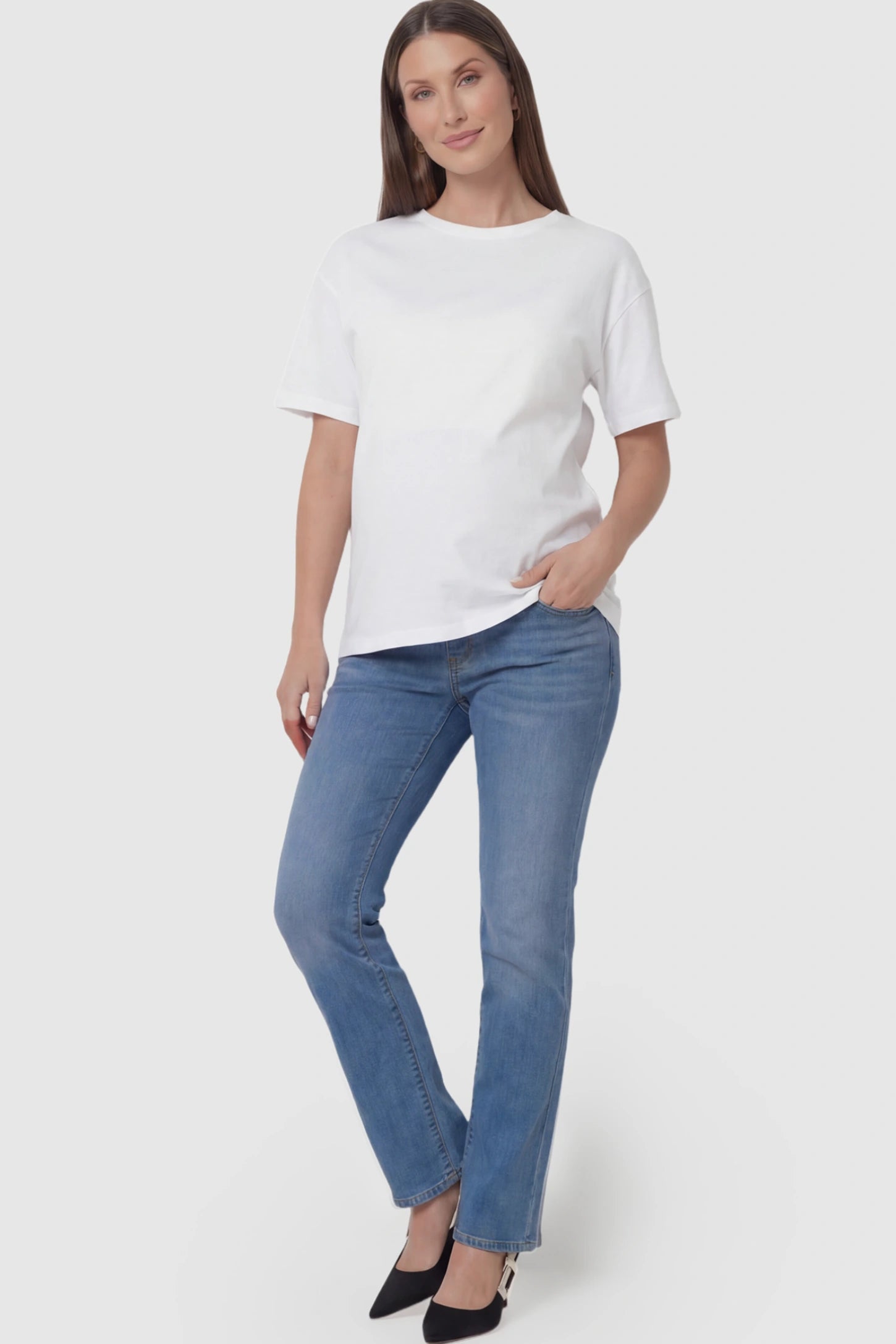 Full Panel Classic Straight Leg Maternity Jeans Full Panel Straight Leg Maternity Jeans in blue featuring a stretch support panel on a pregnant model facing front.