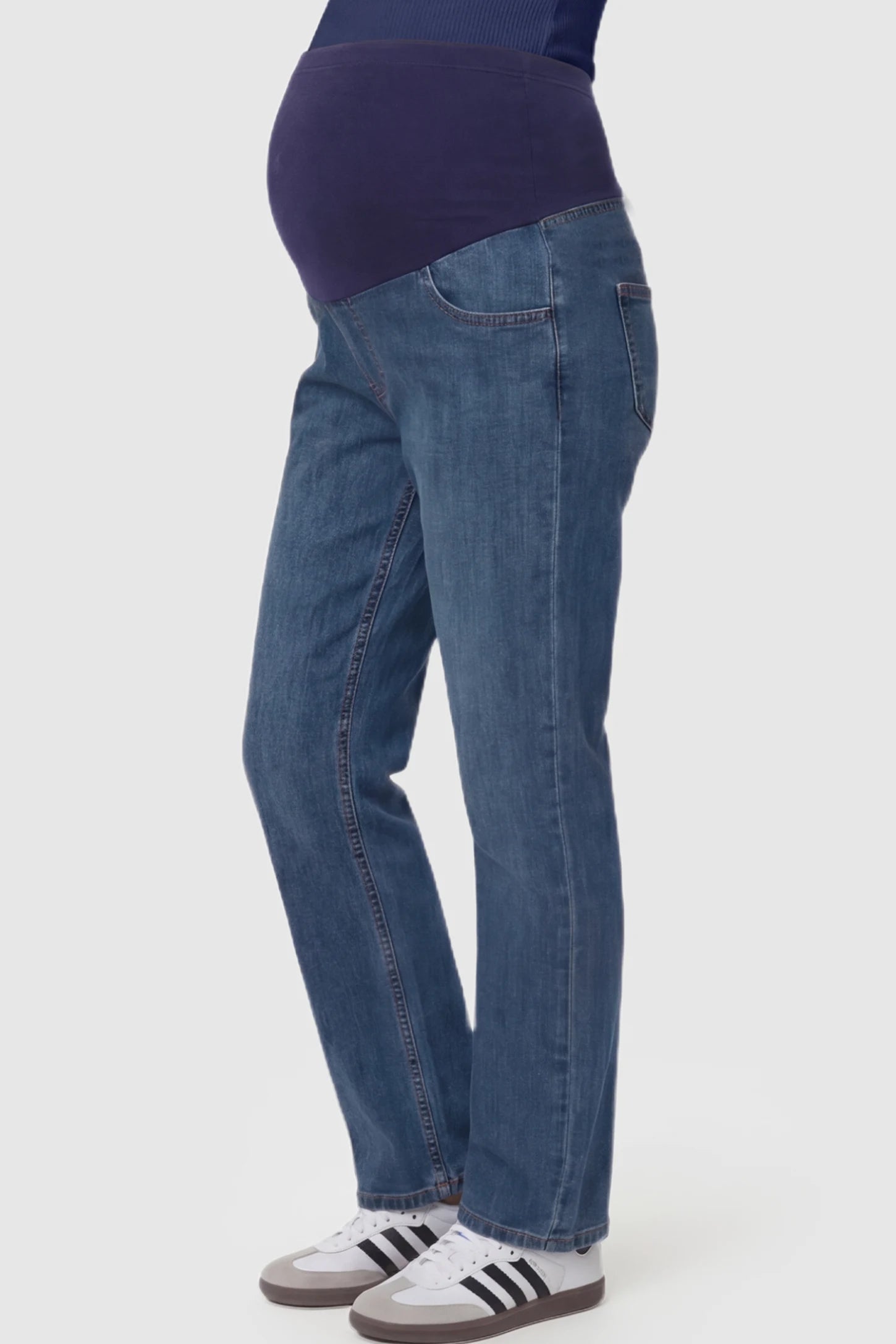 Full Panel Stretch Waistband Straight Leg Maternity Jeans Full Panel Straight Leg Maternity Jeans in Blue featuring a stretch waistband on a pregnant model showing side.