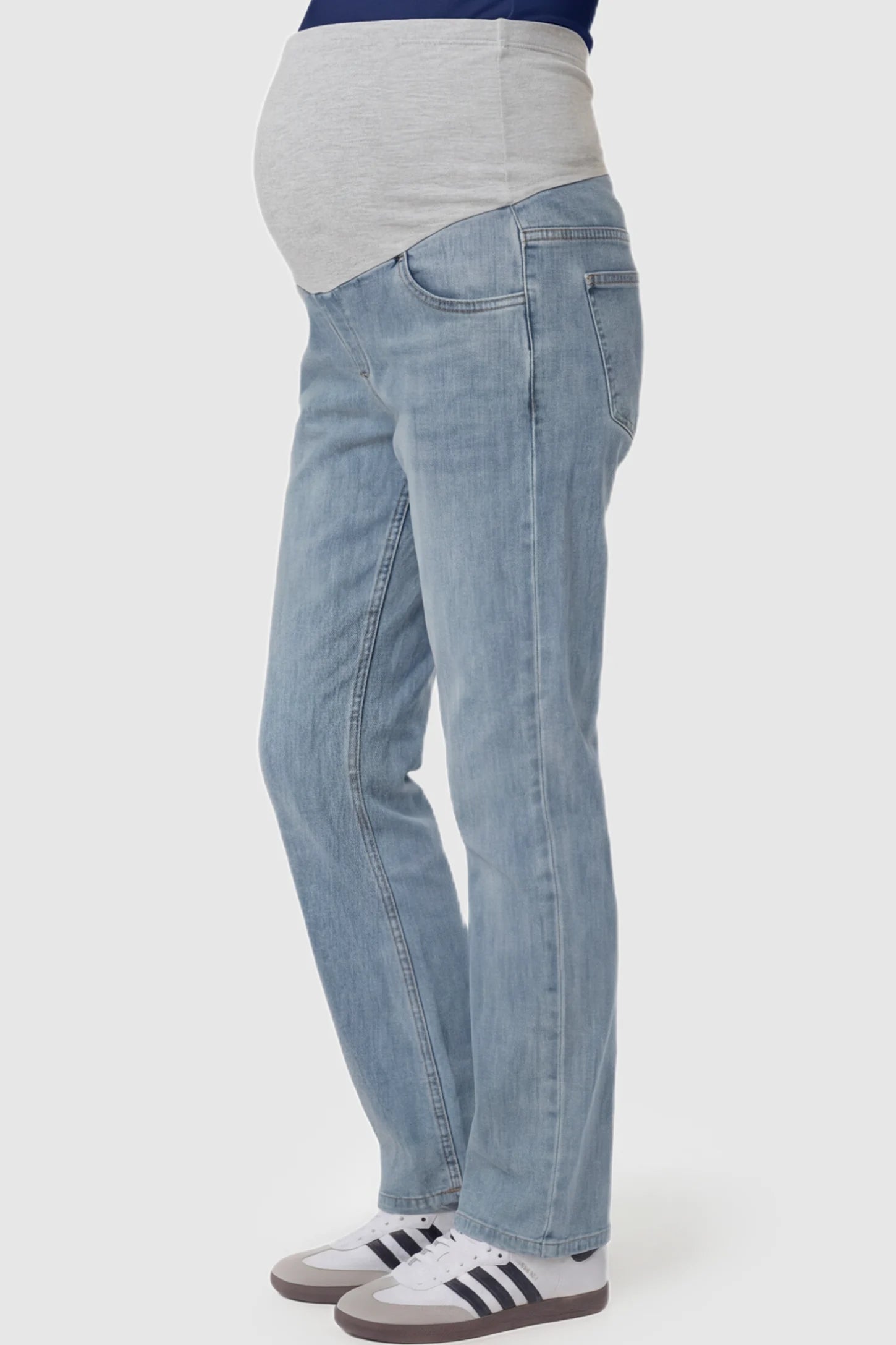 Full Panel Stretch Waistband Straight Leg Maternity Jeans Full Panel Straight Leg Maternity Jeans in light Blue featuring a stretch waistband on a pregnant model showing side.