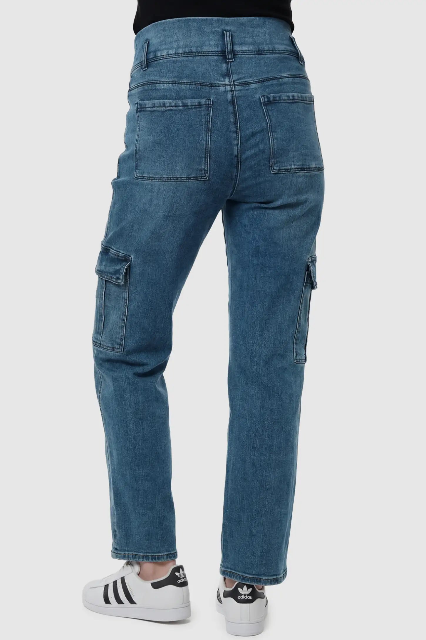 Full Panel Wide Leg Maternity Cargo Jeans Full Panel Wide Leg Maternity Cargo Jeans in Denim Blue featuring functional side flap pockets on a pregnant model back view.