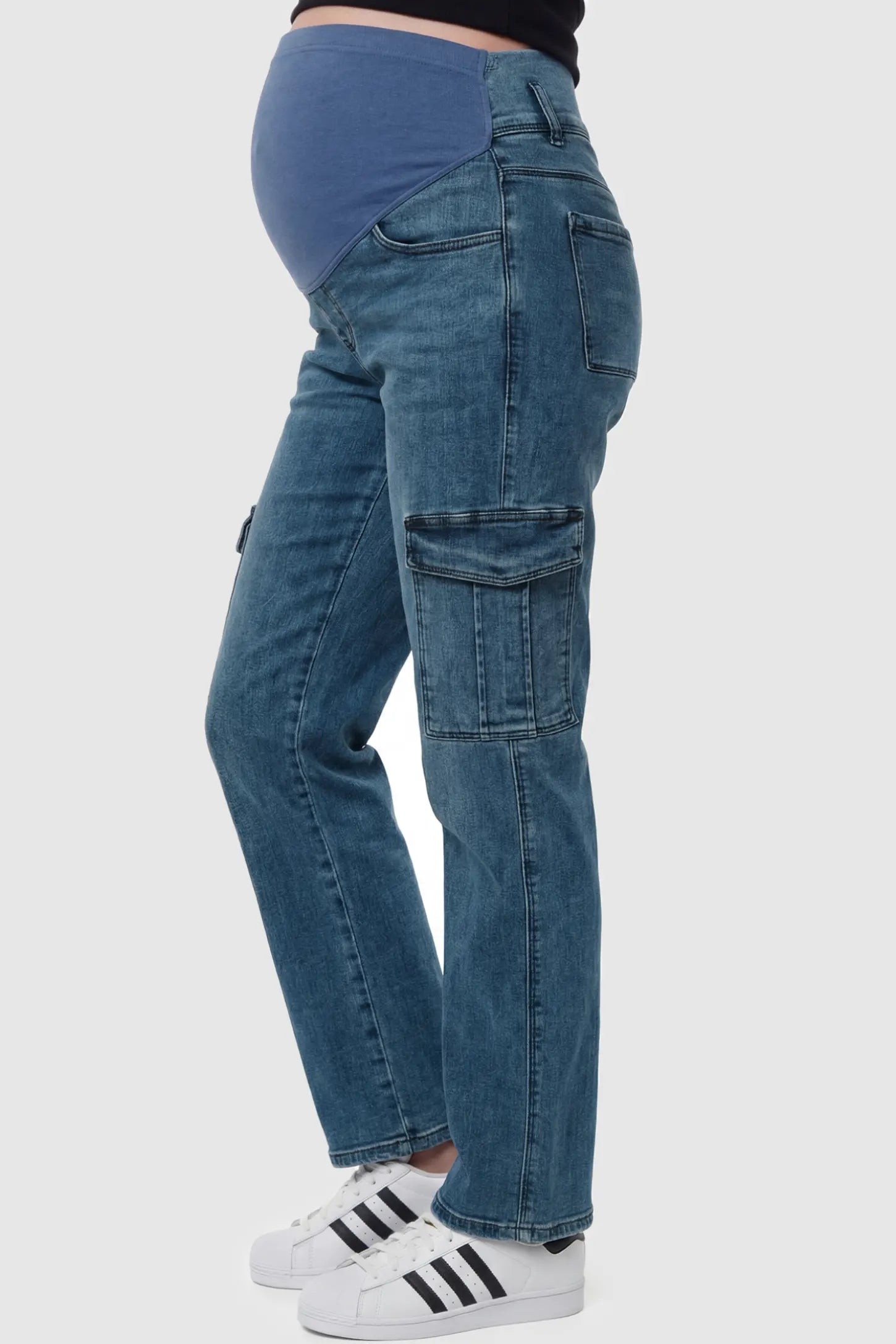 Full Panel Wide Leg Maternity Cargo Jeans Full Panel Wide Leg Maternity Cargo Jeans in Denim Blue featuring functional side flap pockets on a pregnant model side view.