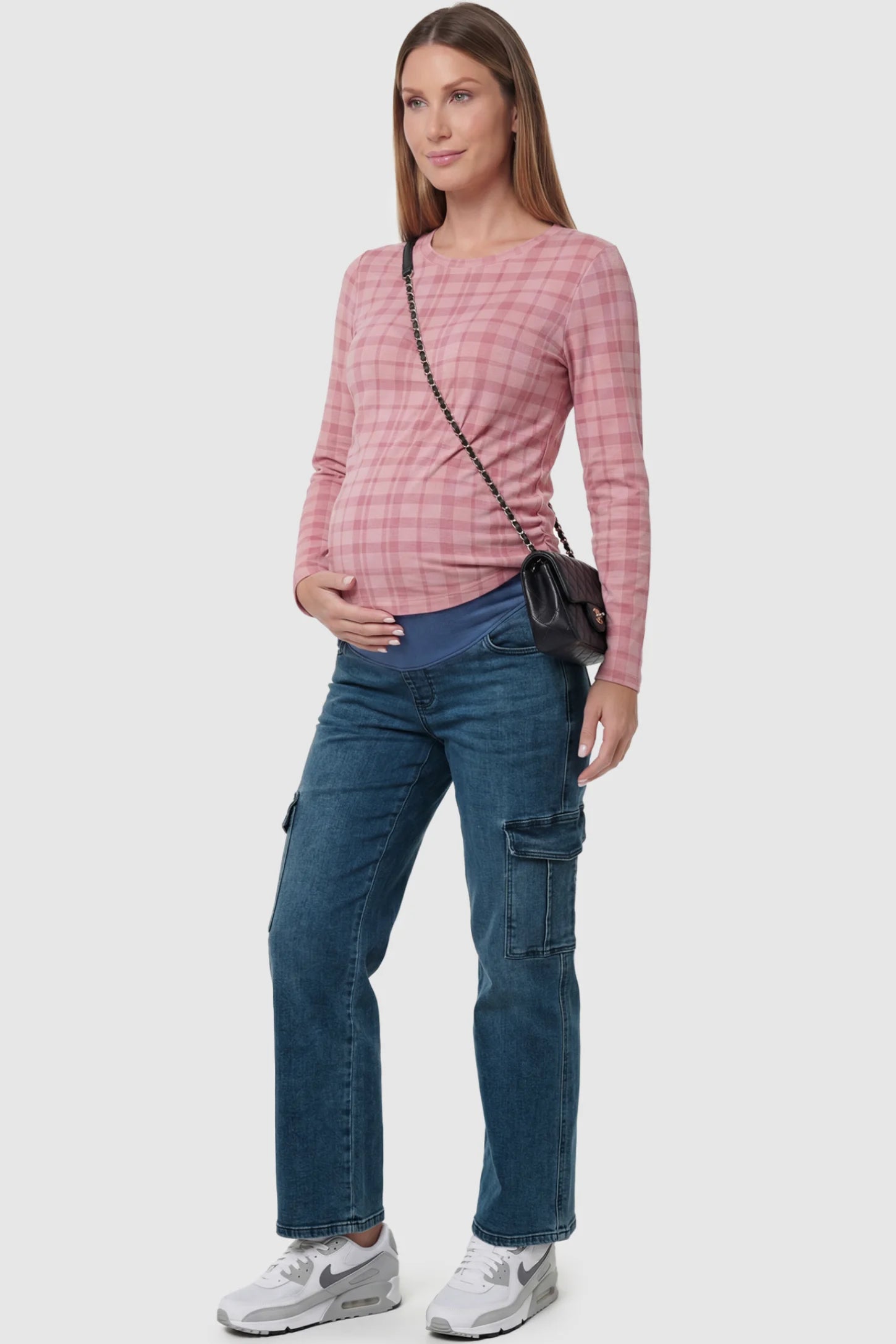 Full Panel Wide Leg Maternity Cargo Jeans Full Panel Wide Leg Maternity Cargo Jeans in Denim Blue featuring functional side flap pockets on a pregnant model side view.
