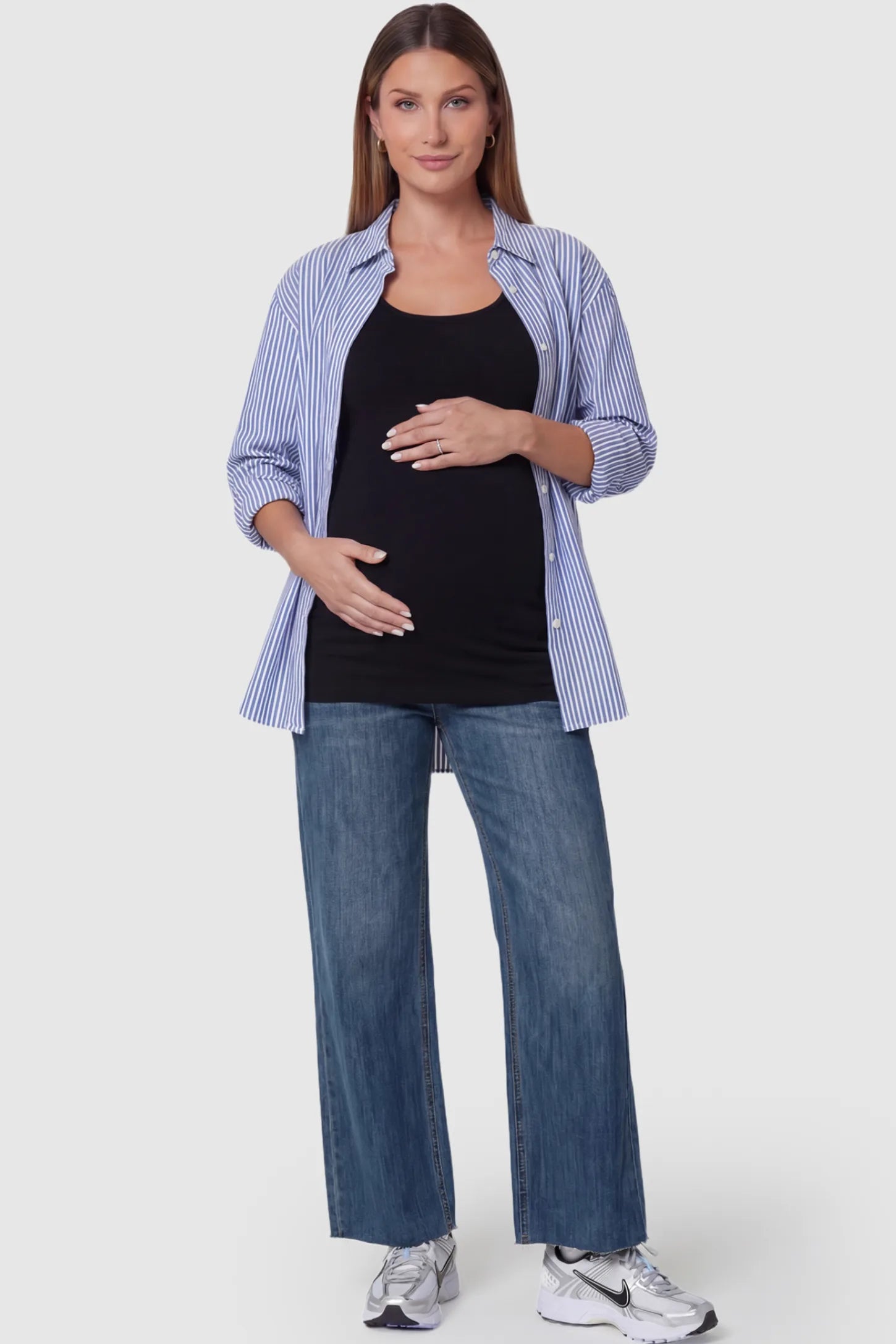 Full Panel Wide Leg Maternity Jeans Full Panel Wide Leg Maternity Jeans in Dark Blue featuring a seamless tummy-support band on a pregnant model facing front.