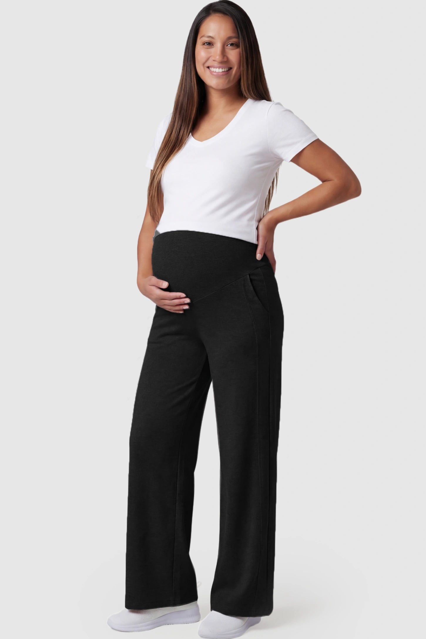 Full Panel Wide Leg Maternity Lounge Pants Full Panel Wide Leg Maternity Lounge Pants in black featuring a high-stretch full belly panel and pockets on a pregnant model showing front.
