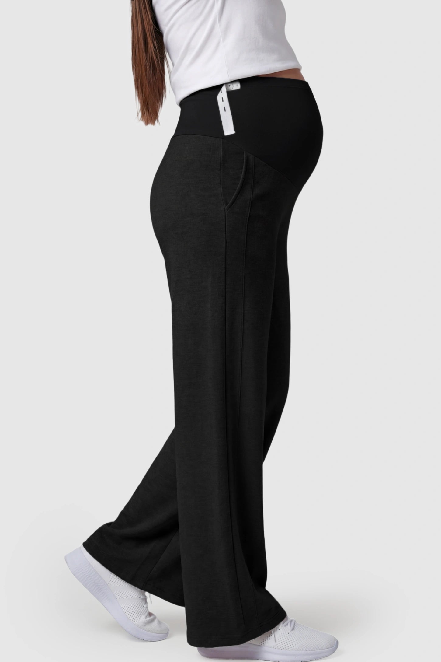 Full Panel Wide Leg Maternity Lounge Pants Full Panel Wide Leg Maternity Lounge Pants in black featuring a high-stretch full belly panel and pockets on a pregnant model showing side.