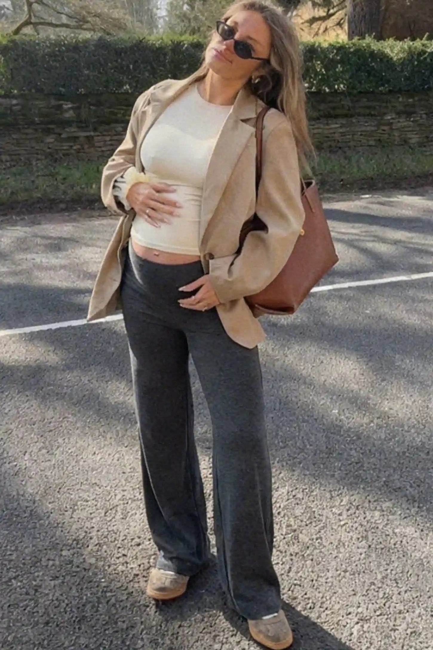 Full Panel Wide Leg Maternity Lounge Pants Full Panel Wide Leg Maternity Lounge Pants in Dark Gray featuring a high-stretch full belly panel and pockets on a pregnant woman.