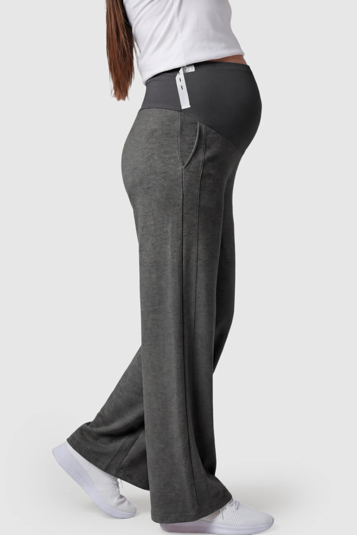 Full Panel Wide Leg Maternity Lounge Pants Full Panel Wide Leg Maternity Lounge Pants in Dark Gray featuring a high-stretch full belly panel and pockets on a pregnant model showing side.