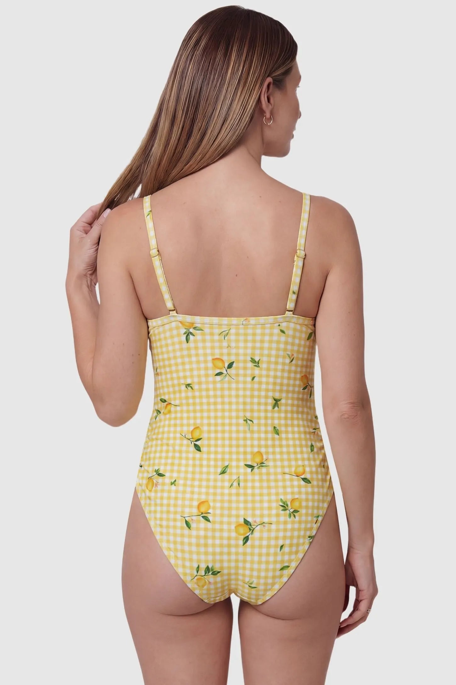 Gingham Matte Ruched Fit Maternity Swimsuit Gingham Matte Ruched Fit Maternity Swimsuit in light yellow with adjustable shoulder straps and gingham print, back view on pregnant model.