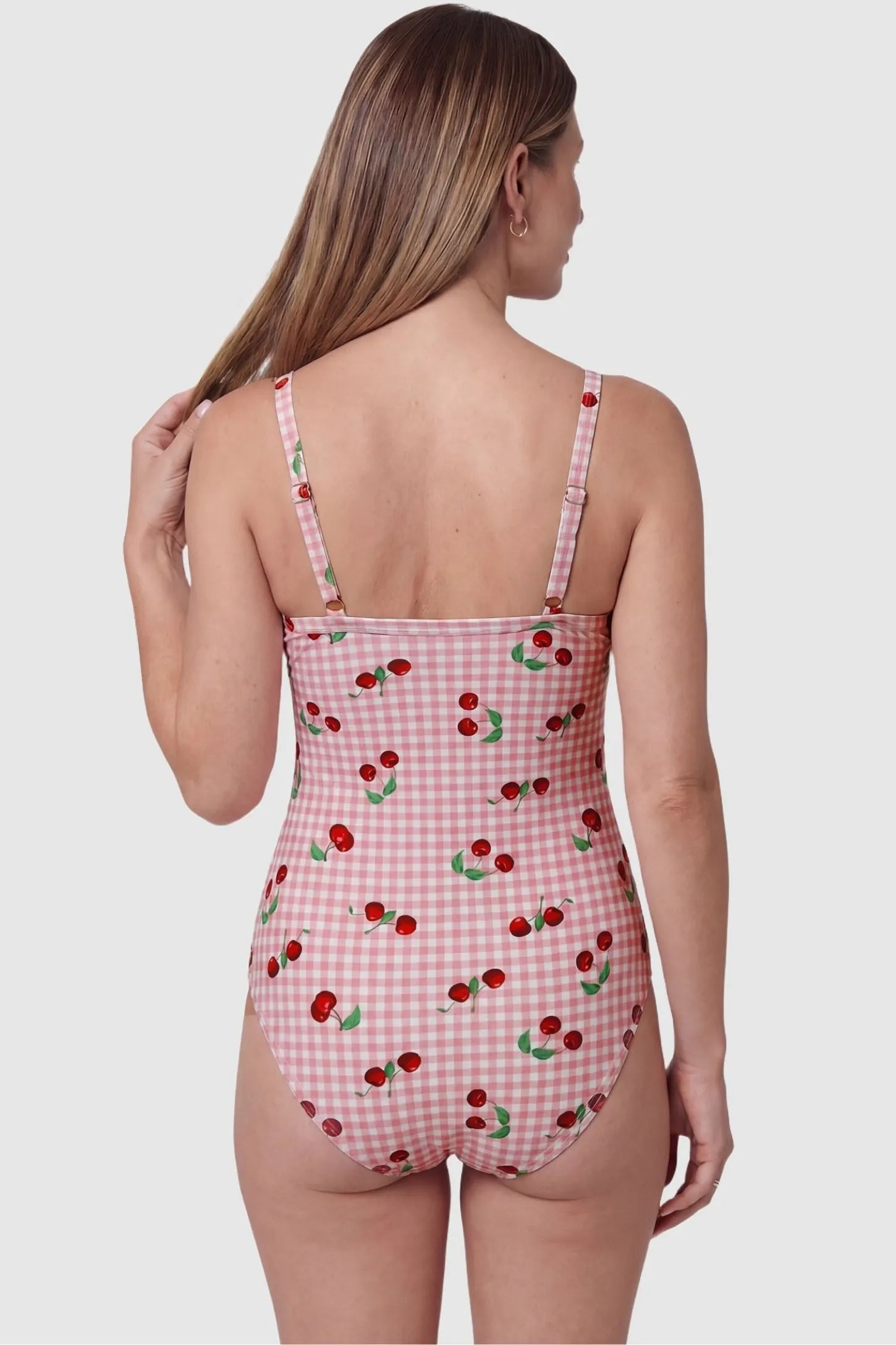 Gingham Matte Ruched Fit Maternity Swimsuit Gingham Matte Ruched Fit Maternity Swimsuit in pink with adjustable shoulder straps, back view on pregnant model.