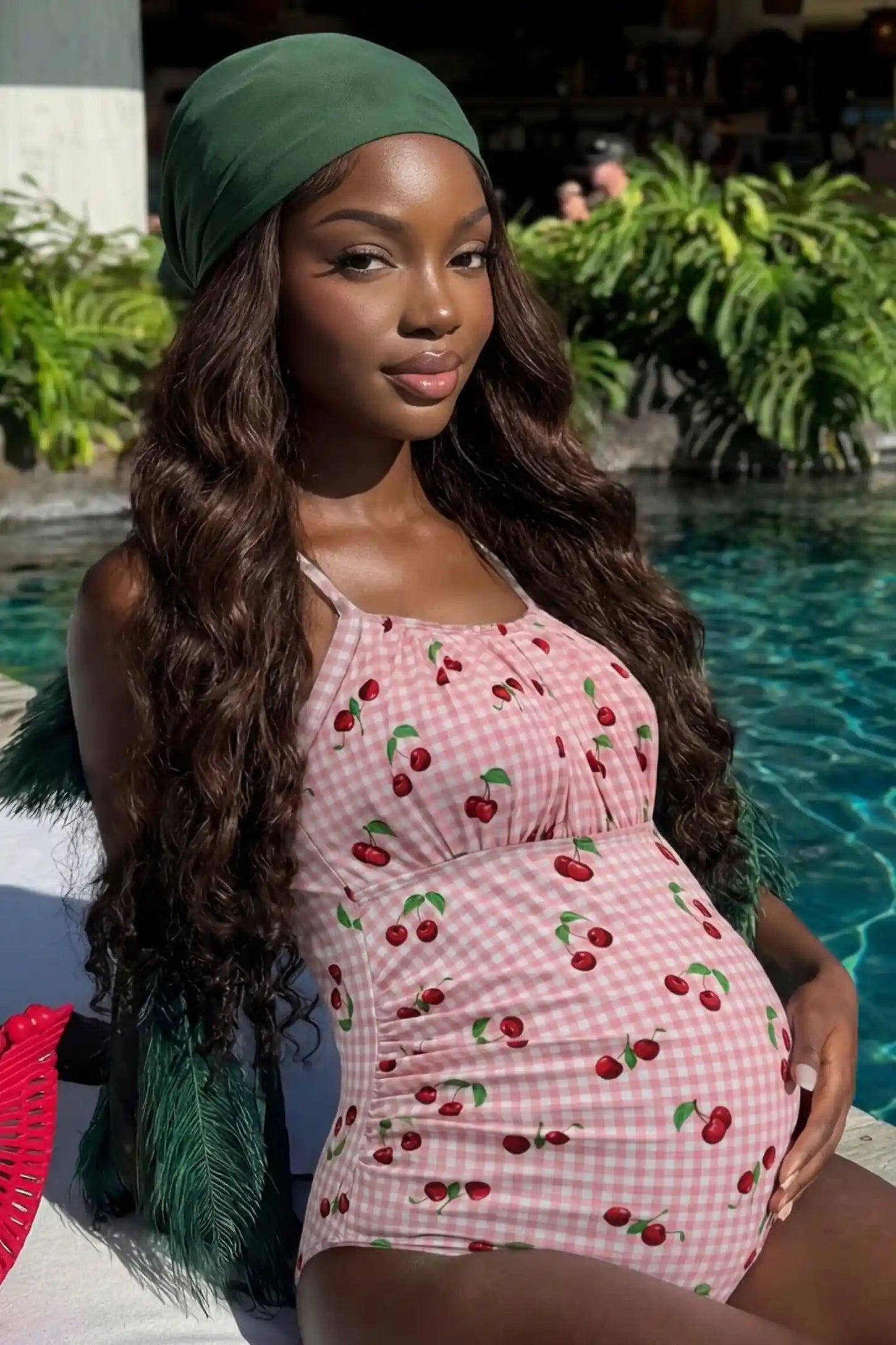 Gingham Matte Ruched Fit Maternity Swimsuit Gingham Matte Ruched Fit Maternity Swimsuit in pink with classic gingham pattern and ruched sides, editorial lifestyle view on pregnant model.