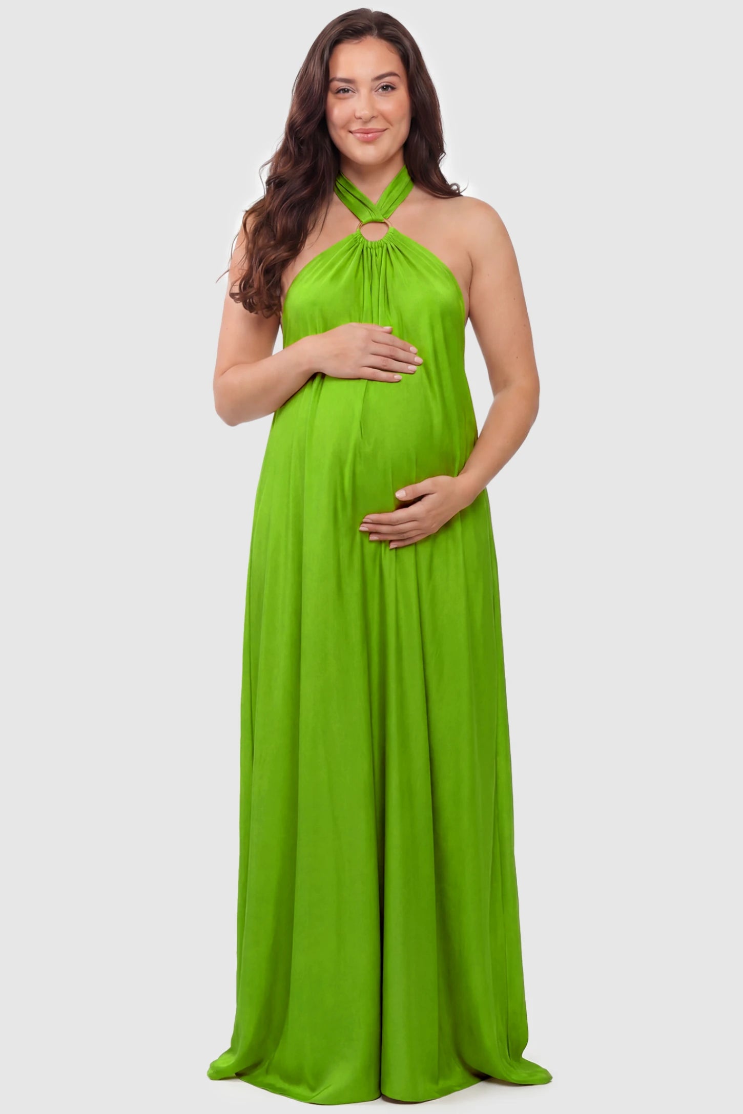 Solid Halter Neck Maternity Maxi Dress Solid Halter Neck Maternity Maxi Dress in Green featuring a flowing skirt on a plus size pregnant model, front view.