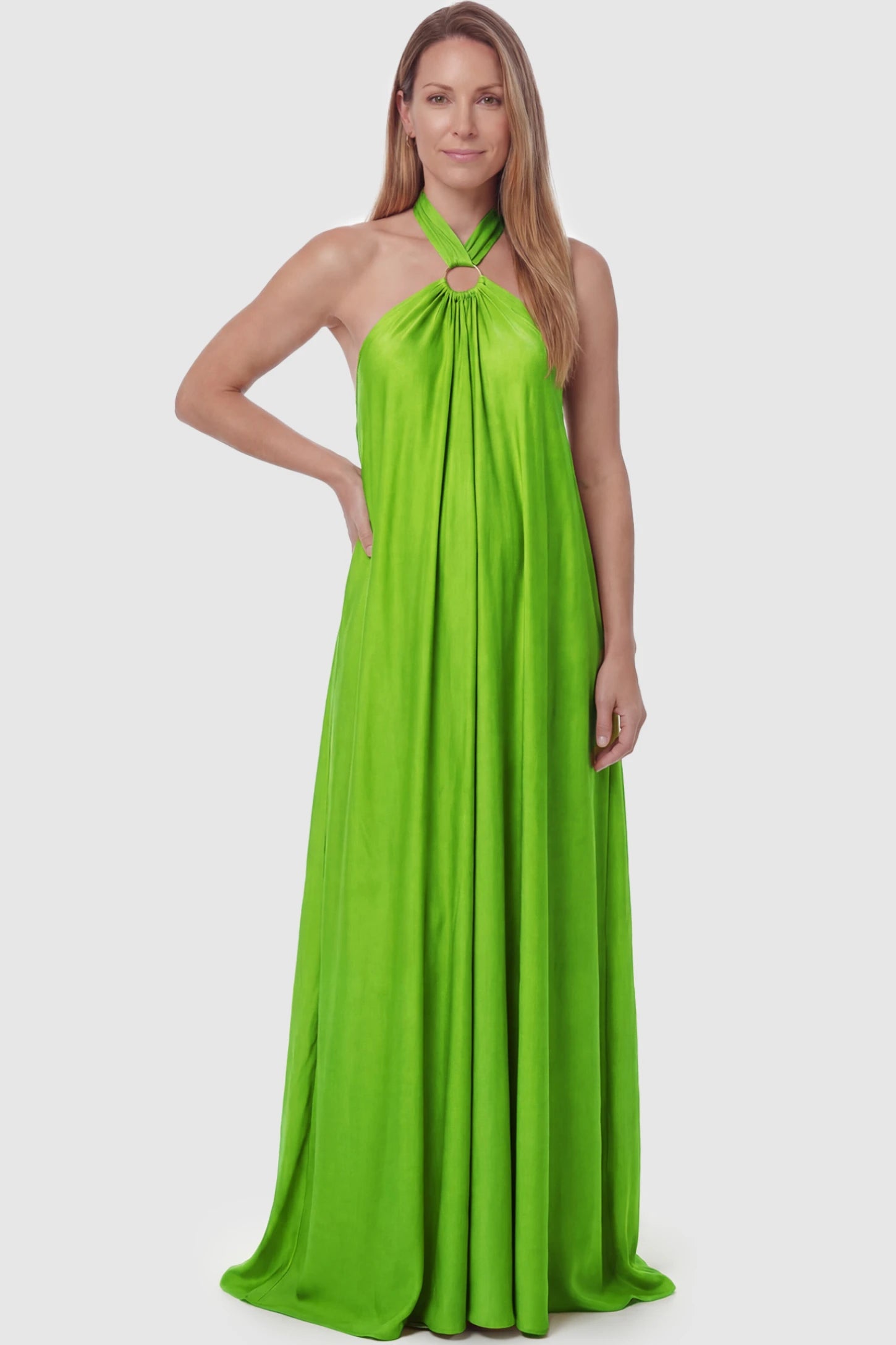 Solid Halter Neck Maternity Maxi Dress Solid Halter Neck Maternity Maxi Dress in Green featuring a flowing skirt on a postpartum model.
