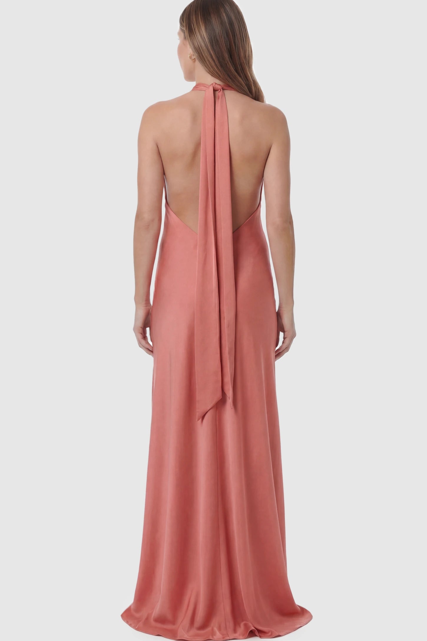 Solid Halter Neck Maternity Maxi Dress Solid Halter Neck Maternity Maxi Dress in Pink featuring a flowing skirt and backless design on a pregnant model showing back.