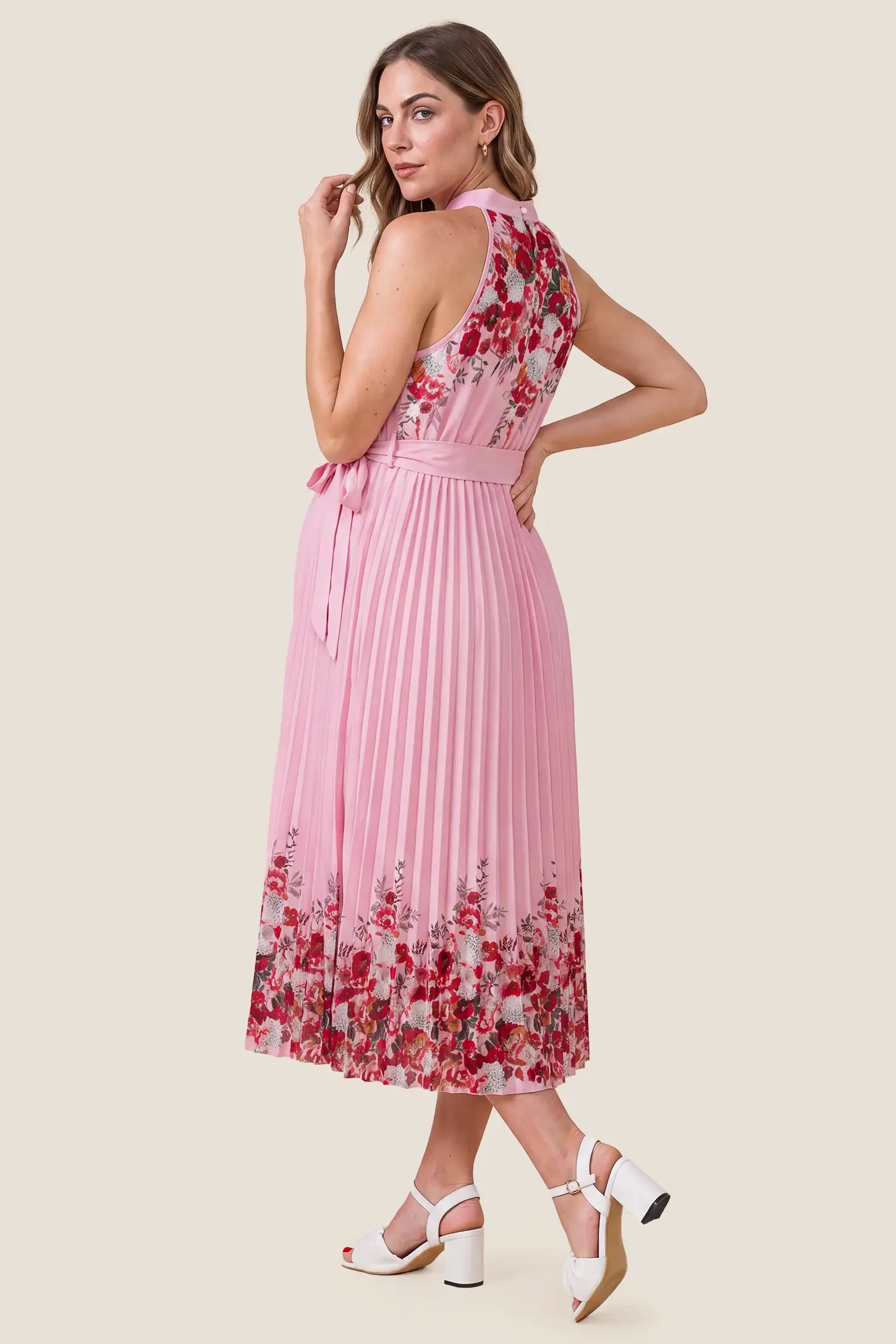 Halter Neck Pleated Maternity Midi Dress Halter Neck Pleated Maternity Midi Dress in Rose Pink Floral showcasing the flowy silhouette on a pregnant model, studio back view.