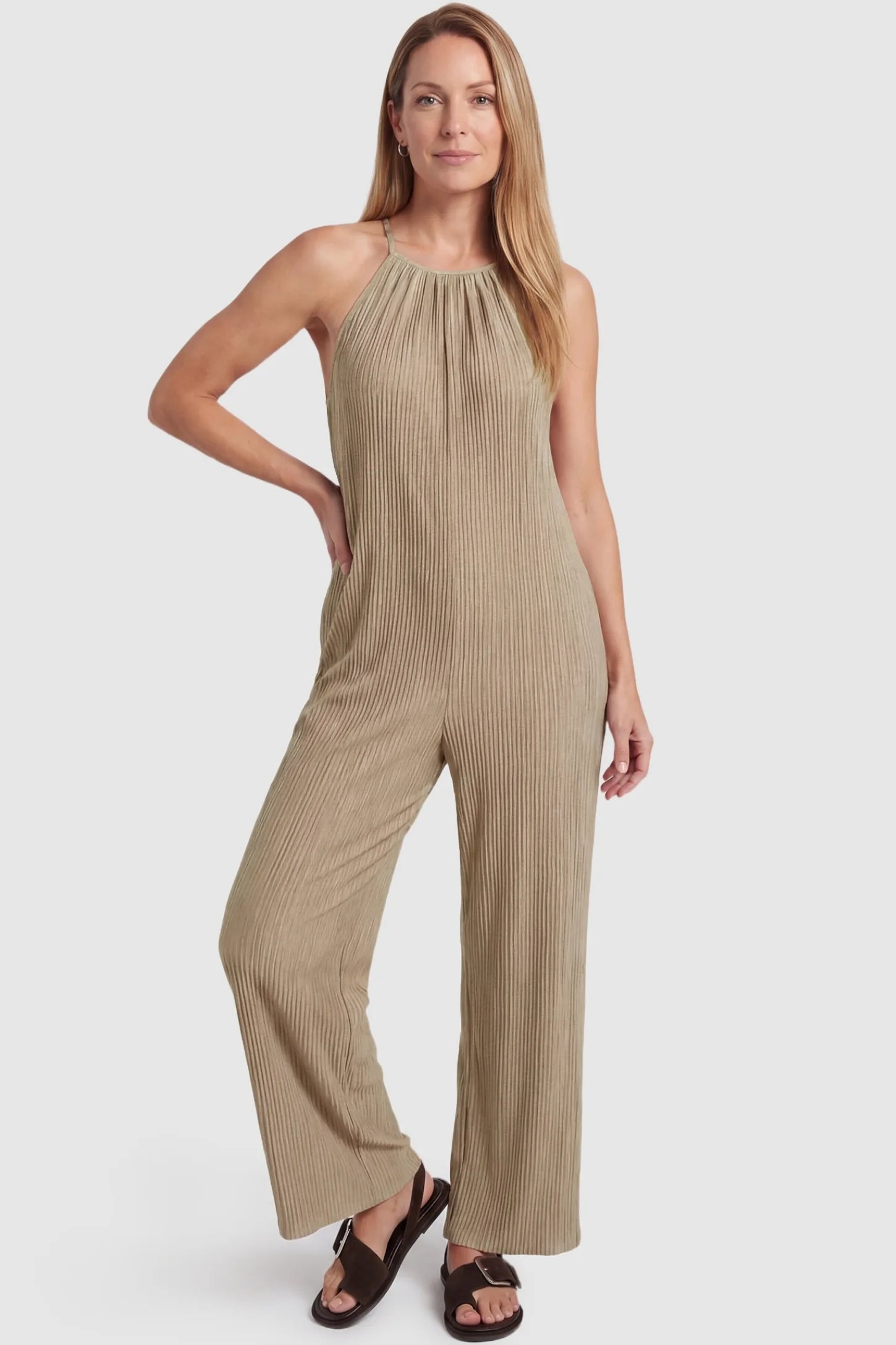 Halter Neck Wide Leg Pocketed Maternity Jumpsuit Halter Neck Wide Leg Pocketed Maternity Jumpsuit in Khaki featuring a halter neck and soft ribbing on a postpartum model, front view.