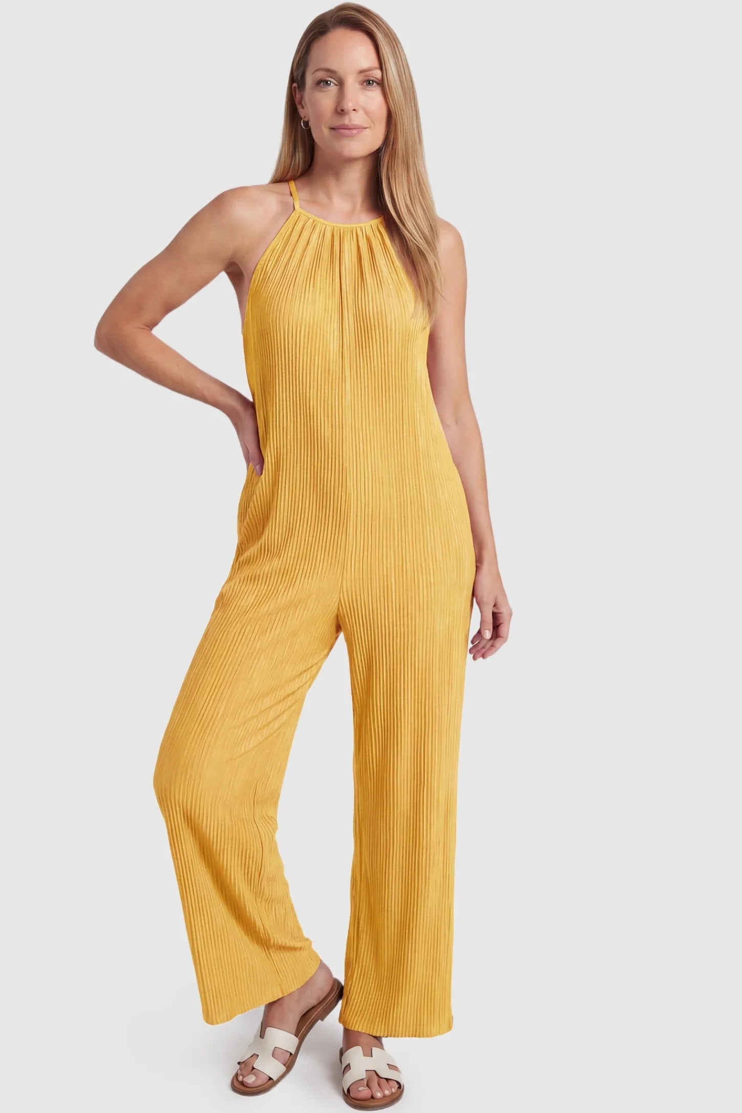 Halter Neck Wide Leg Pocketed Maternity Jumpsuit Halter Neck Wide Leg Pocketed Maternity Jumpsuit in Yellow featuring a halter neck and soft ribbing on a postpartum model, front view.
